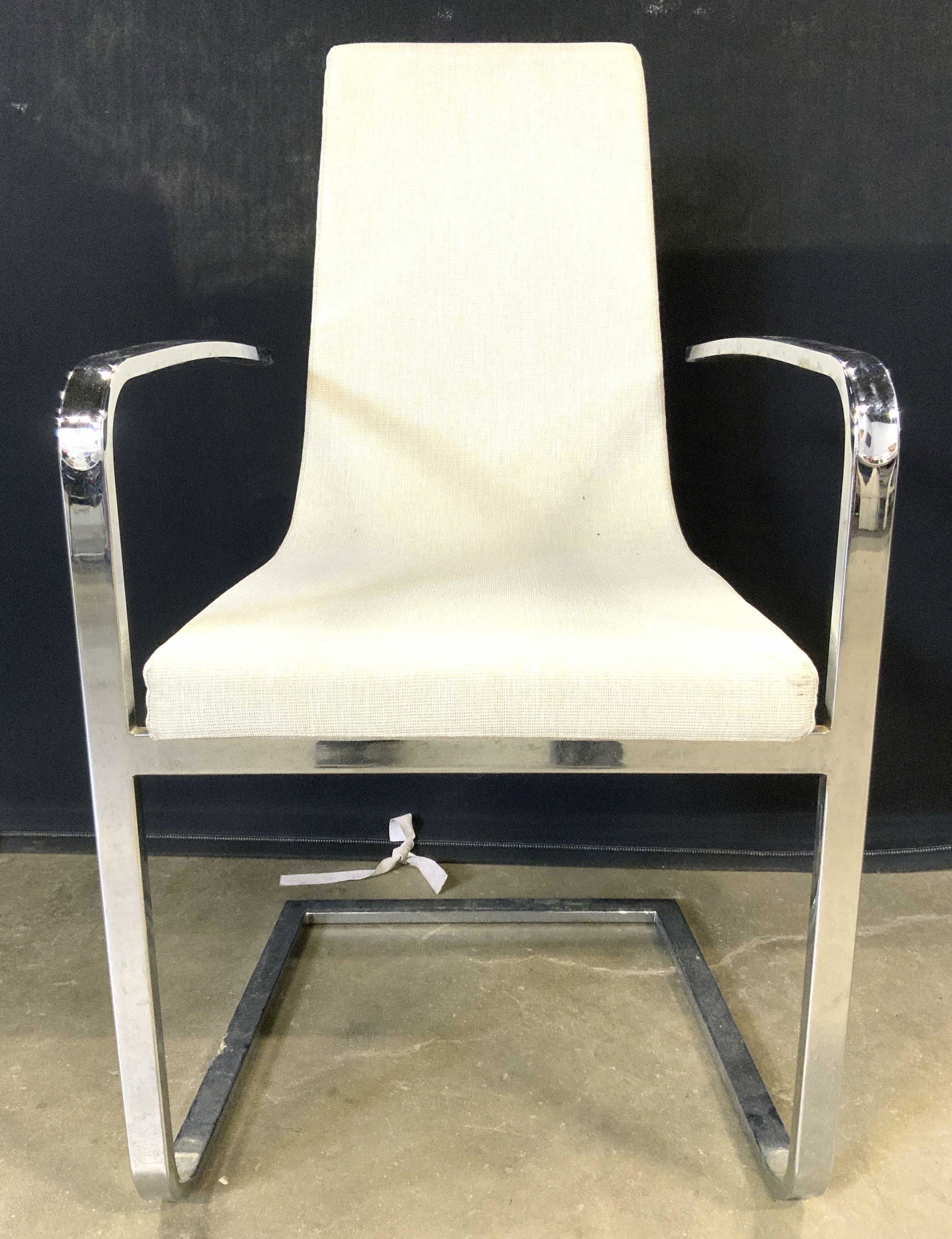 CALLIGARIS Italian Cruiser Chrome Frame End Chair: Lining on underside reads CALLIGARIS. Tag on underside reads MADE IN ITALY. Chair upholstery has a cream slate tone. Chair frame is chrome. Front of armrests have waterfall style structure. Measures a