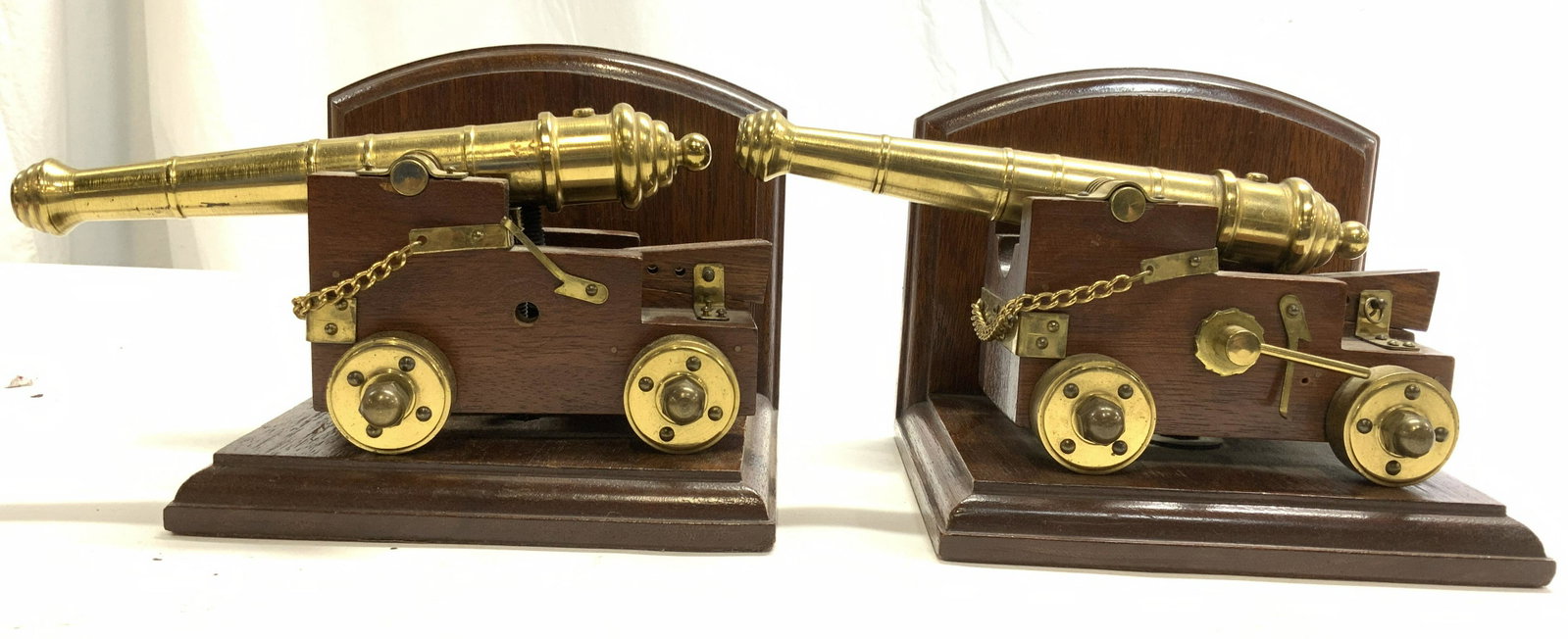 Pair Vintage Wood & Brass Canon Figure Bookends: Lot includes 2 bookends. Each are wooden and brass. Each canon figure has gold toned shaft & wheels. Wooden area is brown toned. Each measures approx 5.25 inches tall 8.5 inches long 5.5 inches deep. 
