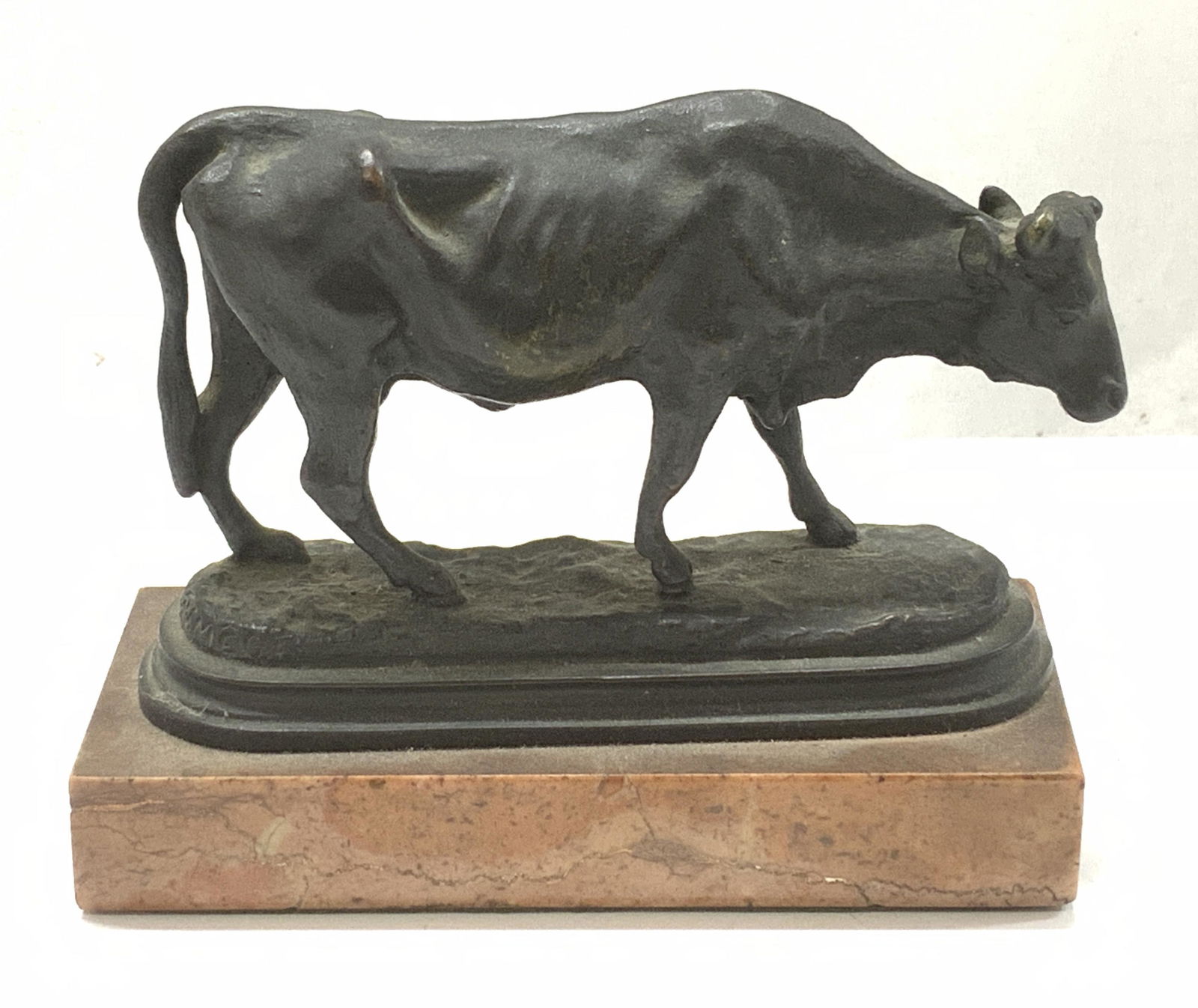 Signed Natural Stone & Bronze Cow Sculpture: Signed Natural Stone and Bronze Cow Sculpture, cast metal believed to be bronze, base is signed P.J. Mege, shows a bronze toned metal withering cow on a warm toned natural stone pedestal, verso is cov