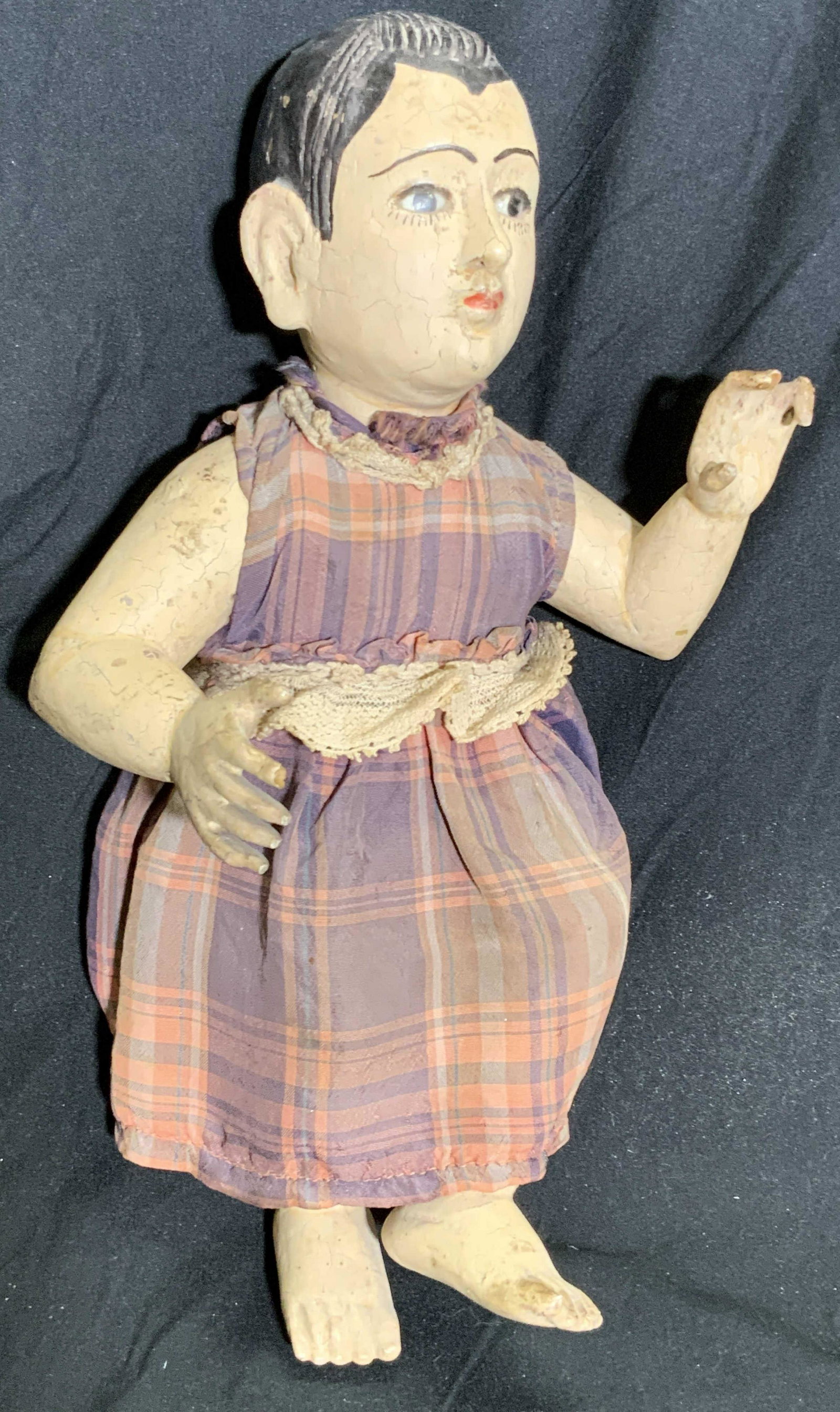 Antique South American Baby Jesus W/ Glass Eyes: Vintage, possibly antique, South American baby Jesus doll / figural that has been hand painted and has glass eyes. The piece appears to be crafted from wood. A fabric dress and diaper dress the piece.