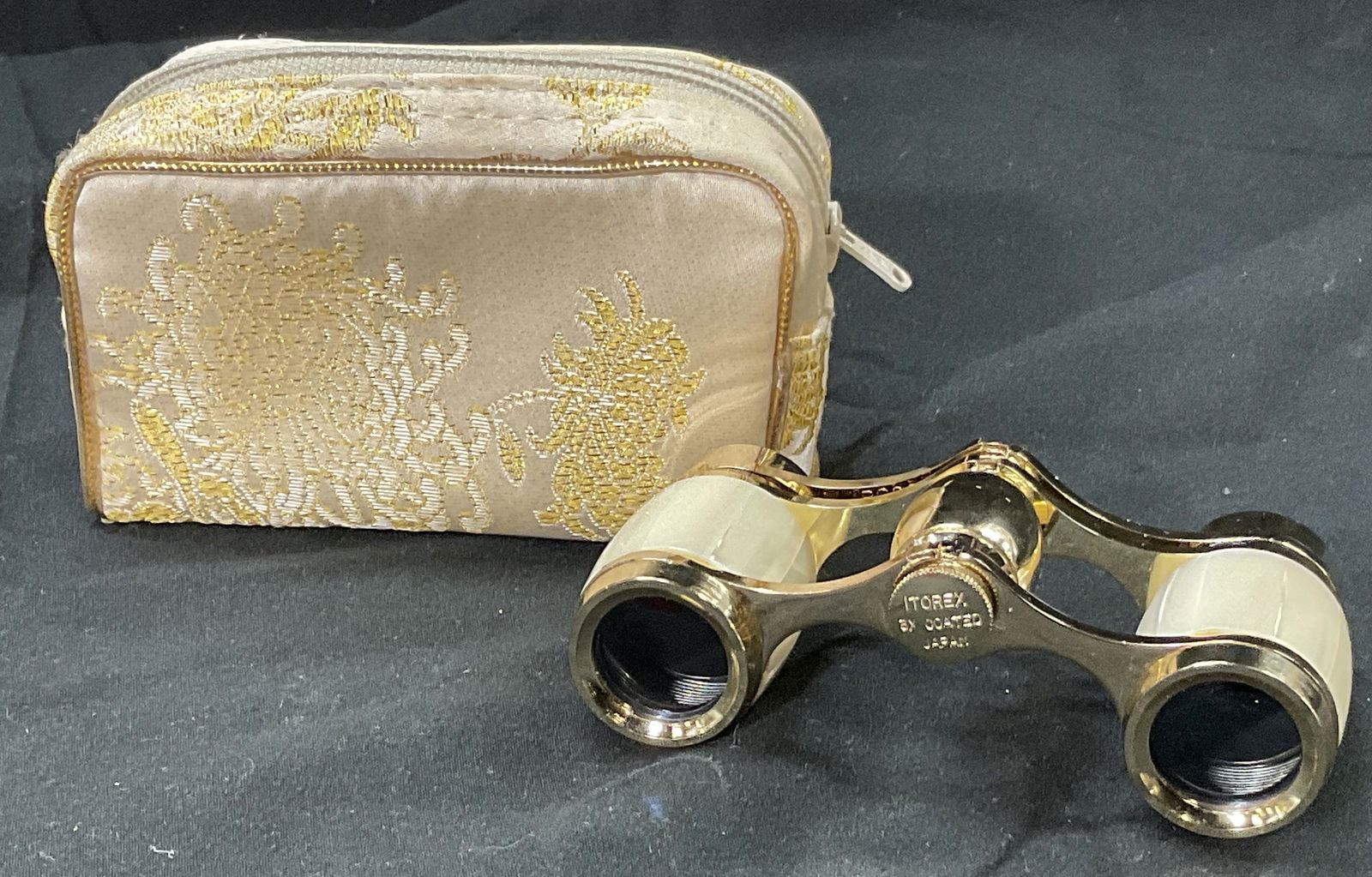 Inlaid Mother Of Pearl Opera Glasses & Pouch: Small opera glasses possibly inlaid with mother of Pearl. Small detailed pouch included with functional zipper. Gold toned material of glasses. Some surface wear to glasses, consistent with use. Japan