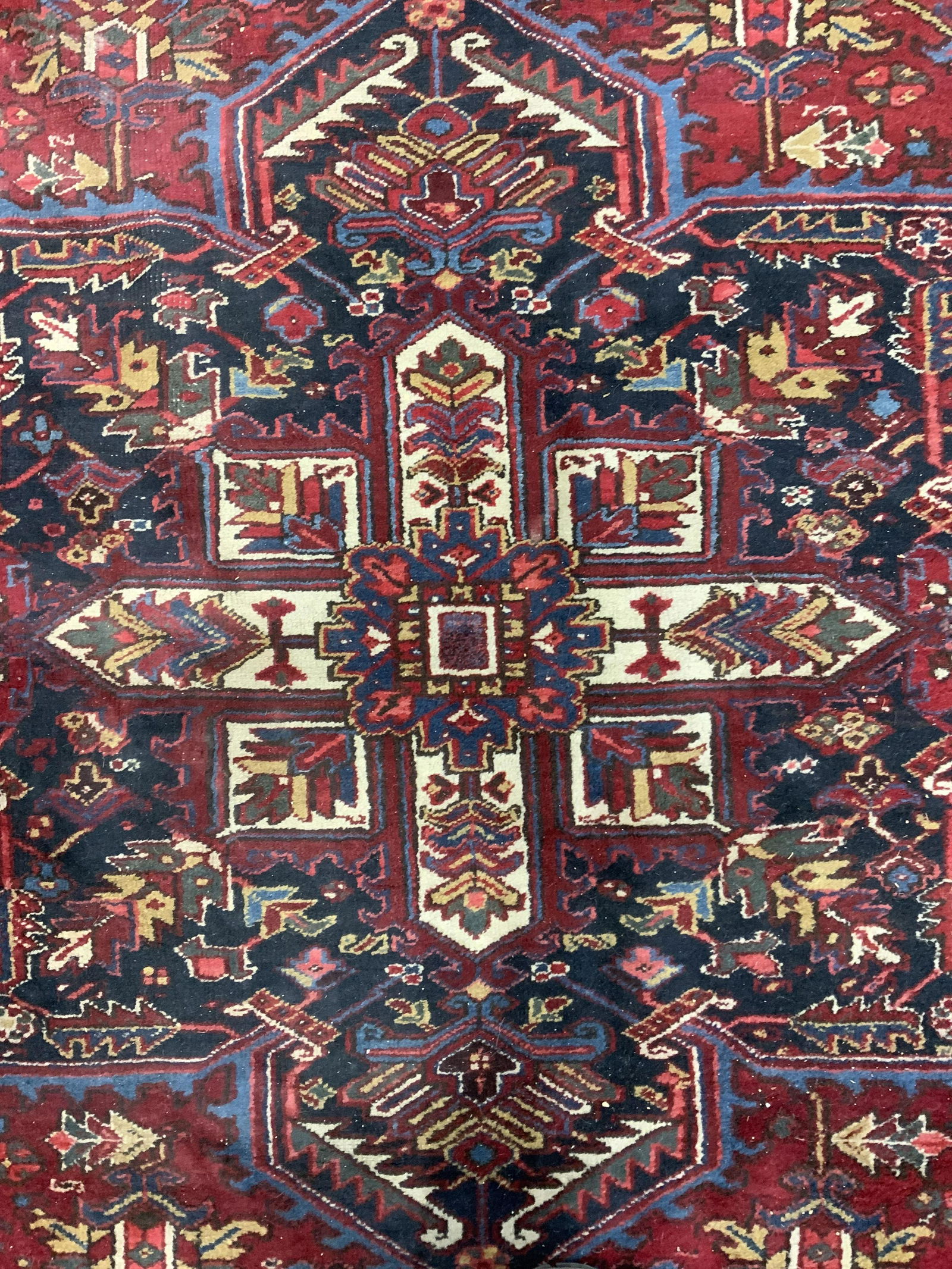 Handmade Vintage HERIZ Oversized Wool Rug: Rug is handmade and wool. Piece is vintage possibly antique. Rug is Persian, appears to be HERIZ. Piece has intricate multi toned floral, leaf & geometric detail. Measures approx 189 inches long 127 i