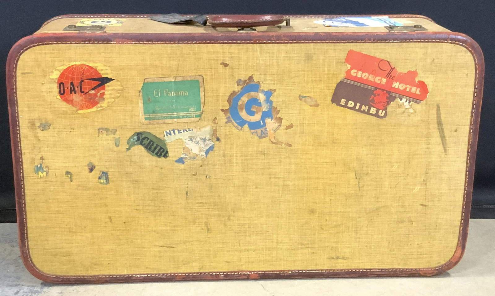 Vintage Suitcase W/ Travel Stickers: Vintage Canvas & Leather Suitcase W/ Travel Stickers Affixed, traditional lock mechanism requiring a key to open, key not included, single top handle, brass toned hardware, leather tag reads Insured H