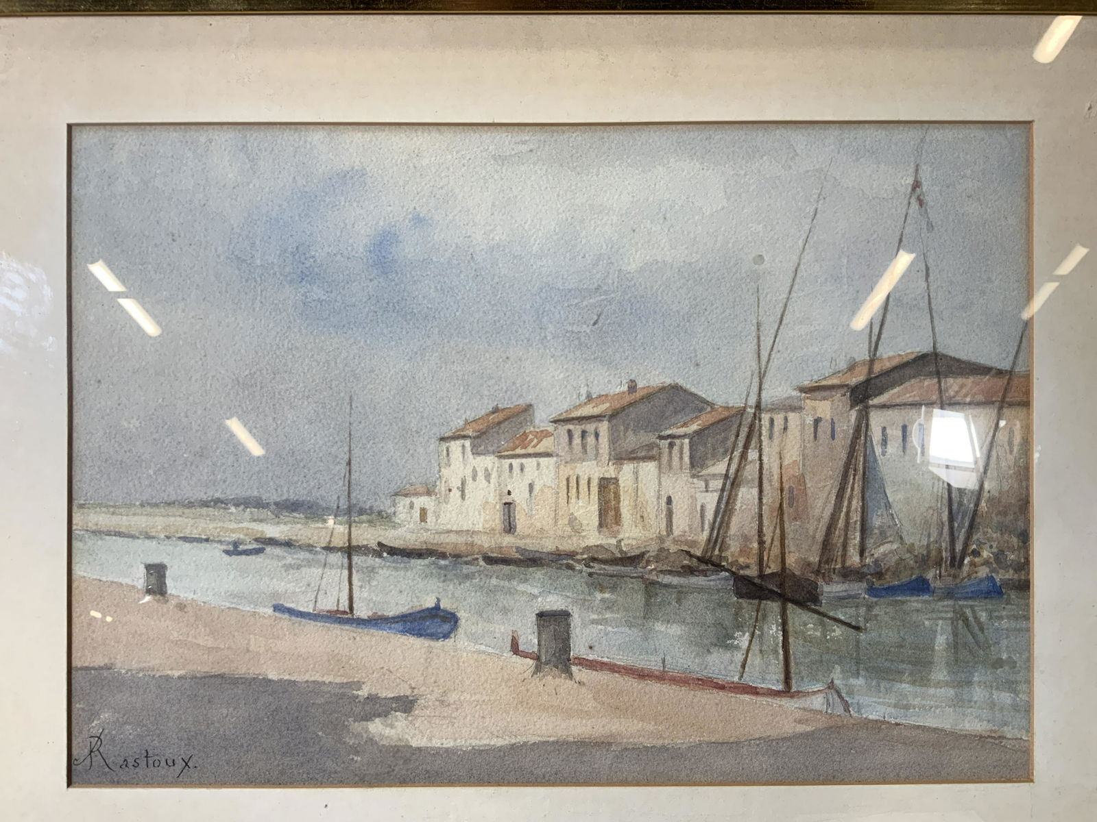 RASTOUX Signed Watercolor of Boat Dock: RASTOUX Signed Watercolor of Boat Dock, signature in ink to lower left reads RASTOUX shows a few boats docked with townscape behind it, measures 16 1/2 x 23 1/2 inches, black and gold toned wood frame