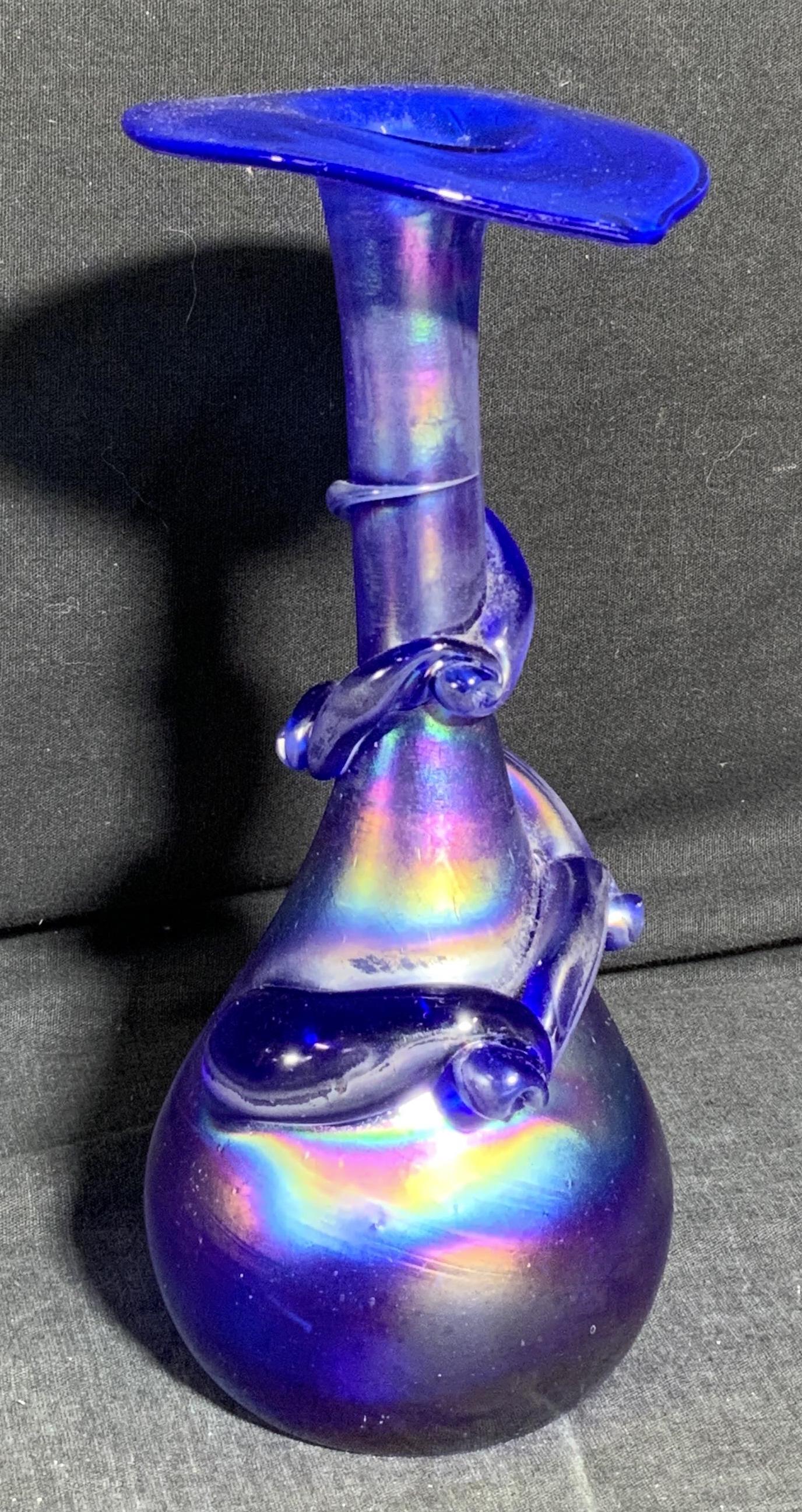 Iridescent Art Glass Vase with Vine Motif: Iridescent Art Glass Vase with Vine Motif, no apparent hallmarks, hand blown glass, Vase rim is pointed on one side. Vase base is wide set. Piece measures approx 8 inches tall 3 1/2 inches wide, some 