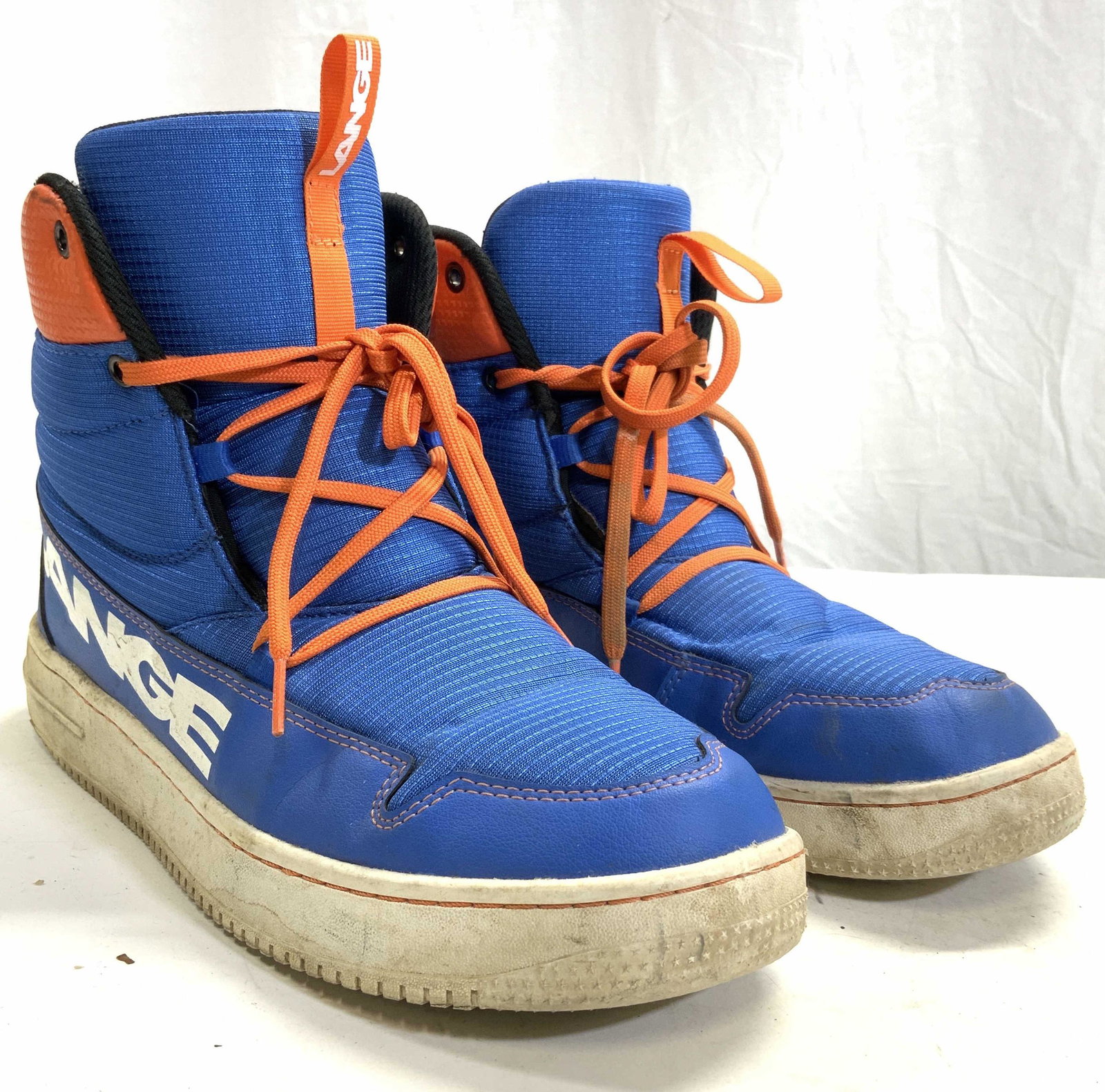 LANGE Podium Soft Shoe Size 10.5: Sides of shoes are marked LANGE on outer sides. Each shoe is blue with orange toned laces, black interior and white lettering. Shoes are size 10.5. Shoes, ski shoes, Lange shoes, podium soft shoes, bl