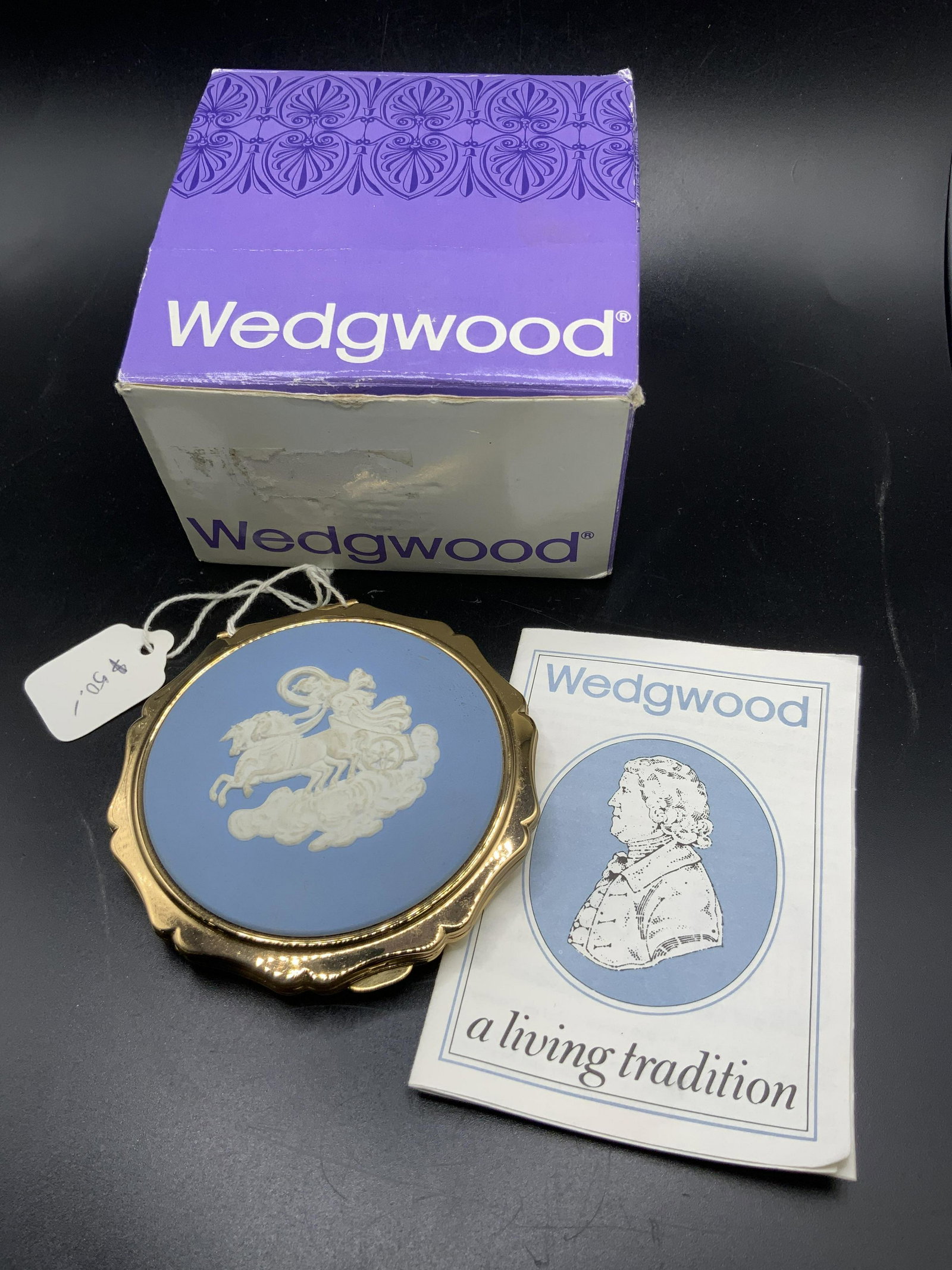 WEDGWOOD Jasperware Mirrored Compact, Org Box: A boxed Wedgwood blue jasperware mirrored compact. Crafted from gold tone polished metal and blue & white Jasperware. Mesh material to interior of compact. Sticker to interior reads The Cameo on this