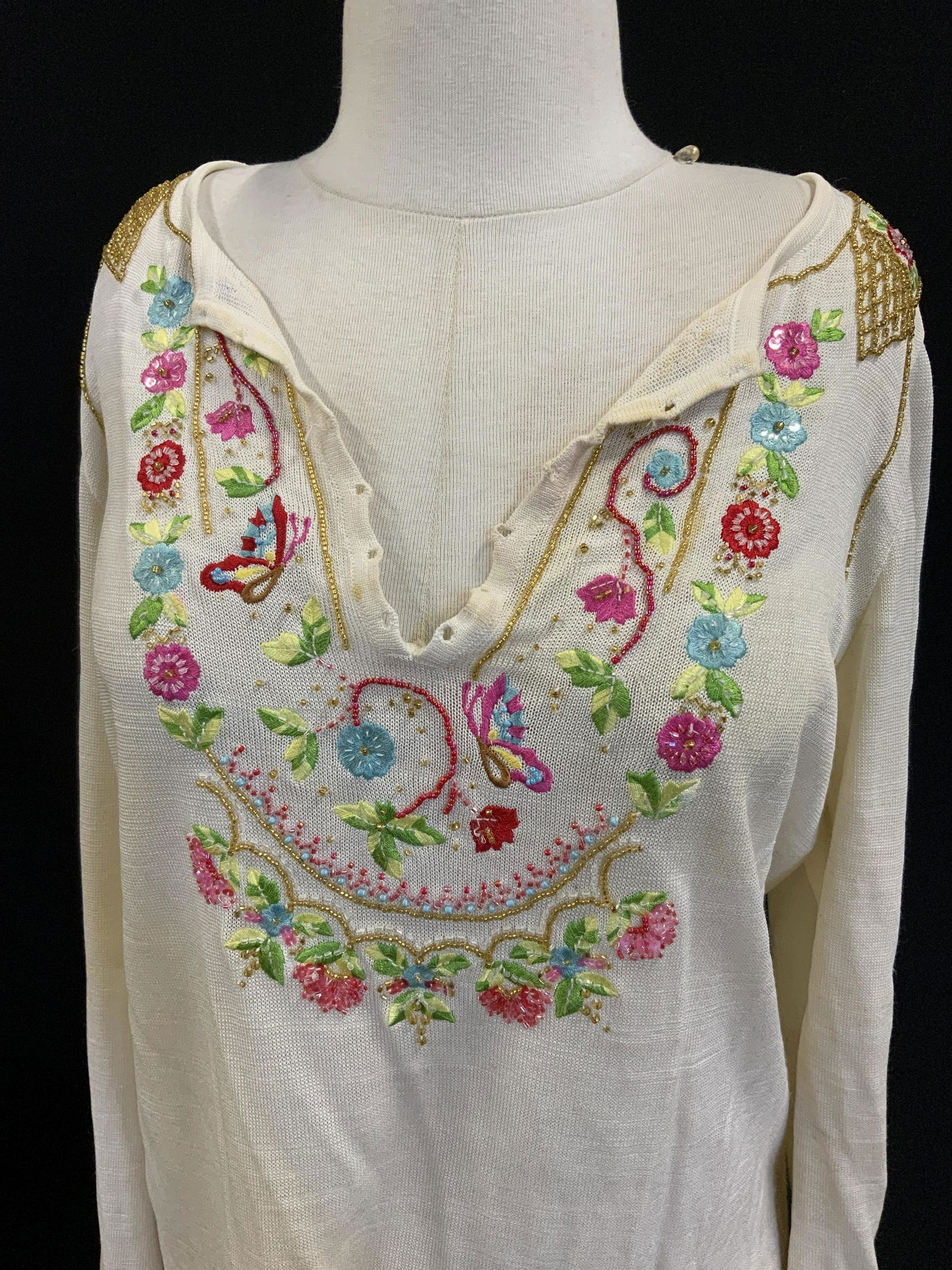 ESCADA Vntg Beaded Long Sleeve Blouse: ESCADA Beaded Long Sleeve, tag reads 42 69% rayon 22% cotton 9% nylon, beaded & embroidered floral and butterfly embellishments throughout, some staining to neck line as well as bottom hem. Property o