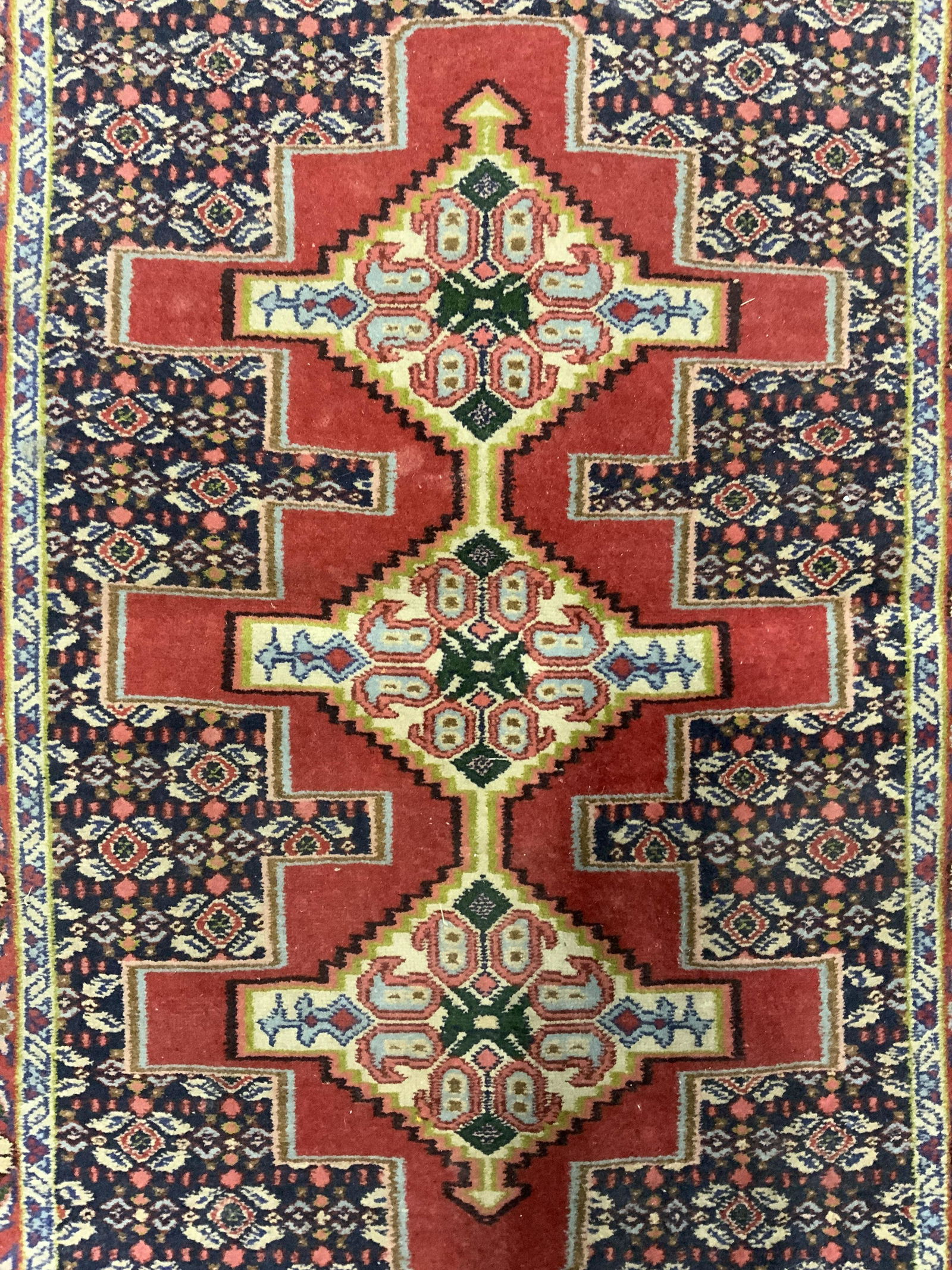 Vintage Handmade Fringed Wool Persian Rug: Rug is handmade and wool. Piece is vintage possibly antique. Rug is possibly Kazak. Piece has intricate multi toned floral, leaf, & geometric detail. Piece has slate toned fringes at edges. Measures a