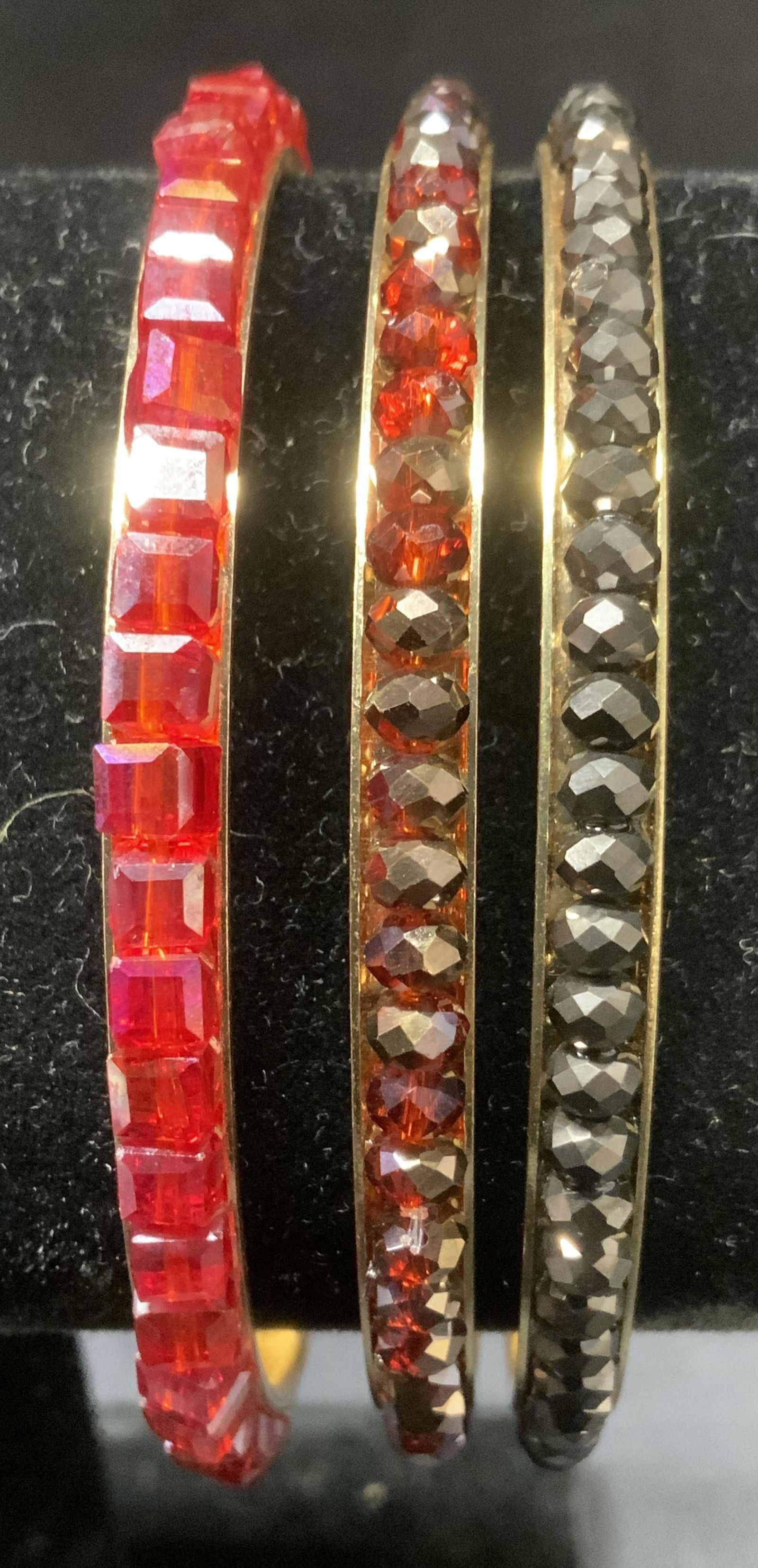 Lot of 3 Rhinestone Bangles: Lot of 3 Rhinestone Bangles, gold toned hardware, one with pink square rhinestones, one with red circular rhinestones, and one with black circular rhinestones, each measure approx 1/4 in. wide. Proper