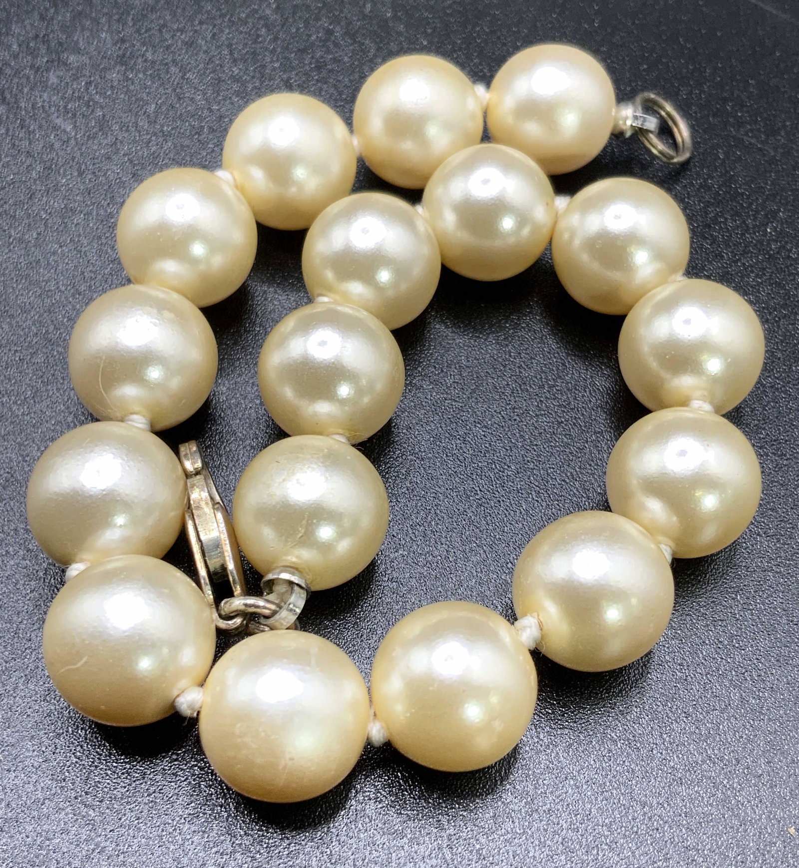 Vintage STERLING SILVER Clasp Pearlescent Bracelet: A vintage bracelet comprised of pearlescent beads. Lobster claw clasp marked 925, sterling silver. Some surface wear to piece consistent with use and age. Bracelet length approx 8 in. Total weight of 