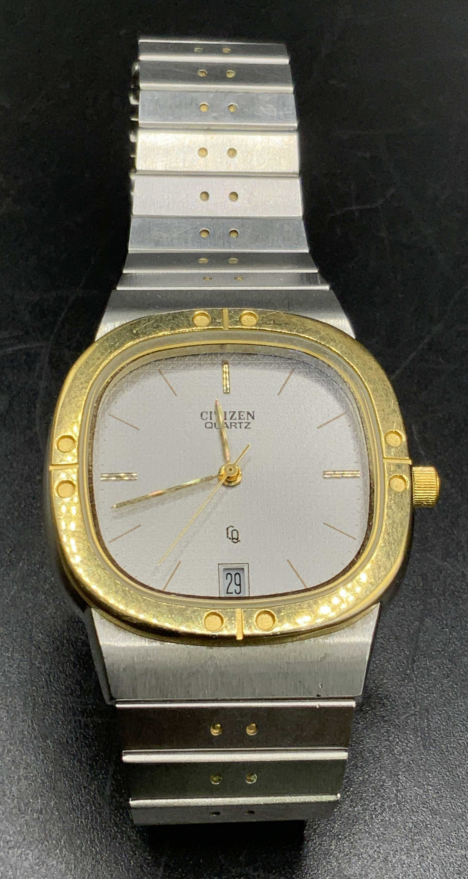 CITIZEN QUARTZ Silver & Gold Tone Metal Wristwatch: Comprised of silver and gold toned metals. Watch face reads CITIZEN QUARTZ. Reverse reads BASE METAL SSG, WATER RESISTANT. Watch band reverse reads Stainless Steel. Watch length approx 8.5 in. Propert