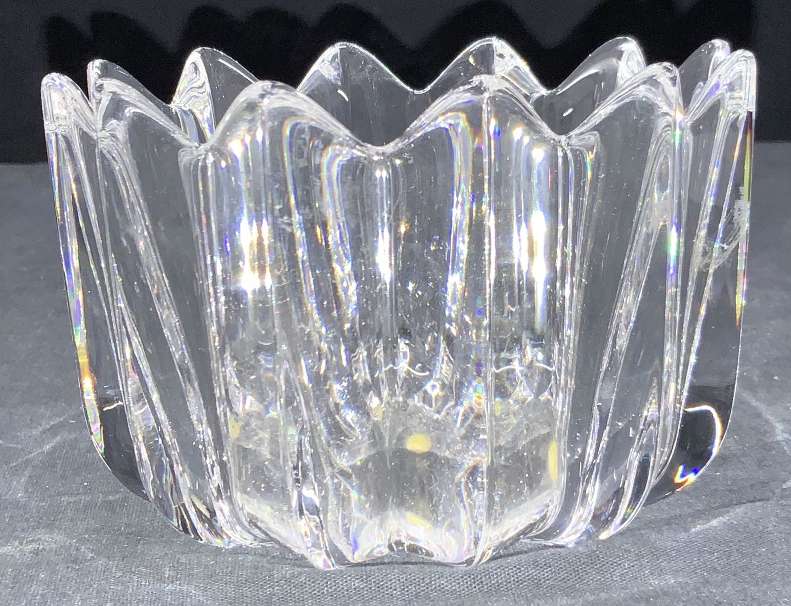 Orrefors Signed Cut Crystal Bowl, Sweden: Cut crystal broke with saw tooth rims and cut triangular grooves on exterior. Marked on sticker and etched on underside Orrefors. Approximately 3.25 inches tall and 4.75 inch diameter. Orrefors cut cr
