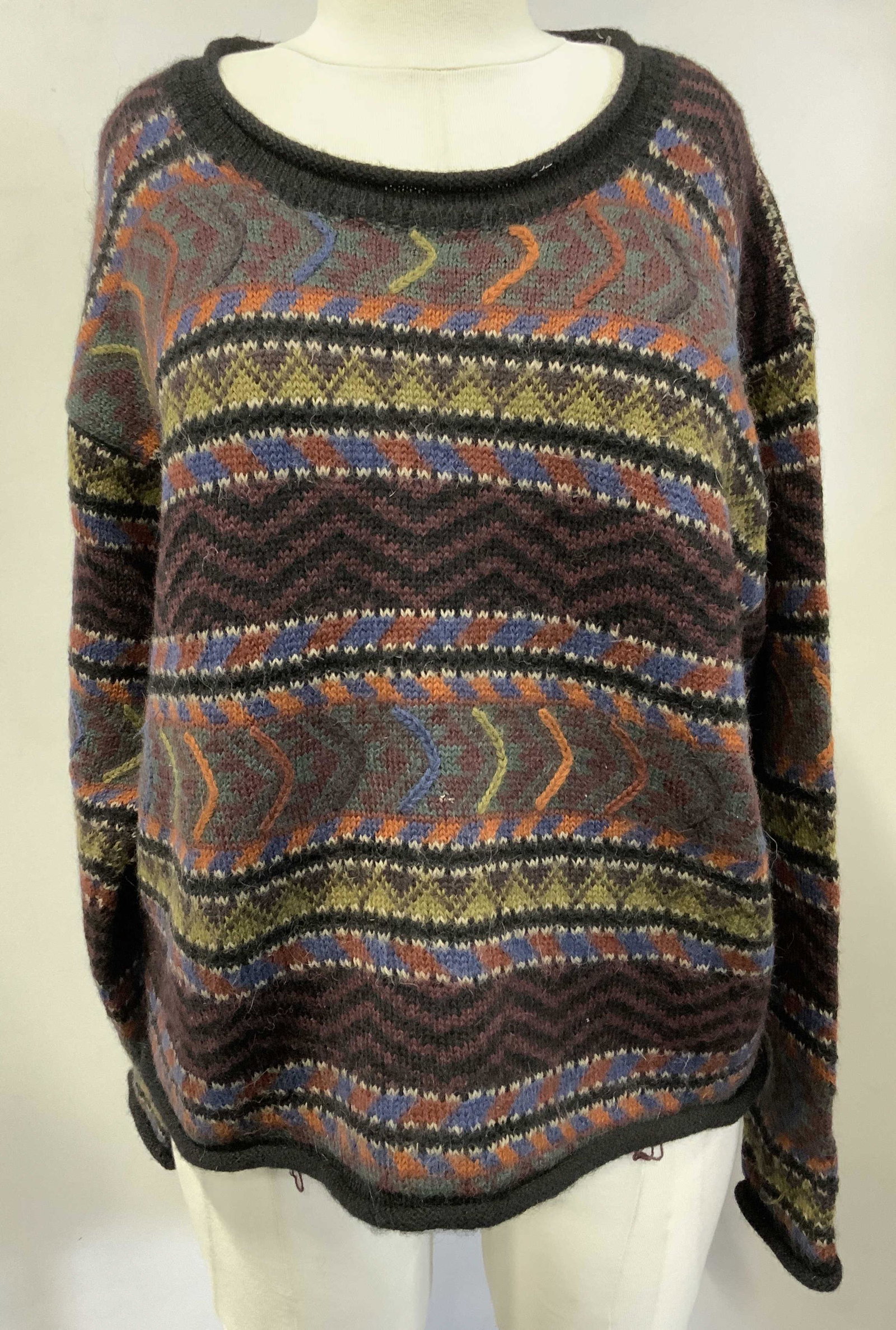 THE PERUVIAN CONNECTION XL Woven Sweater: Tag reads THE PERUVIAN CONNECTION 100% ALPACA HANDMADE IN PERU XL. Sweater is possibly crop top length. Piece has multi toned geometric detail. Appears to be womens XL size. The Peruvian Connection sw