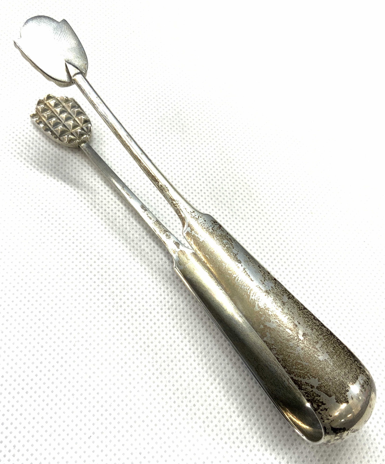 HM Signed Vintage Serrated Tongs: Set of vintage white metal tongs with serrated grips. Possibly ice tongs. Marked 84 HM on interior. Approximately 5.25 inches long. Etched on sides of handles Minor wearing to metal due to age and use