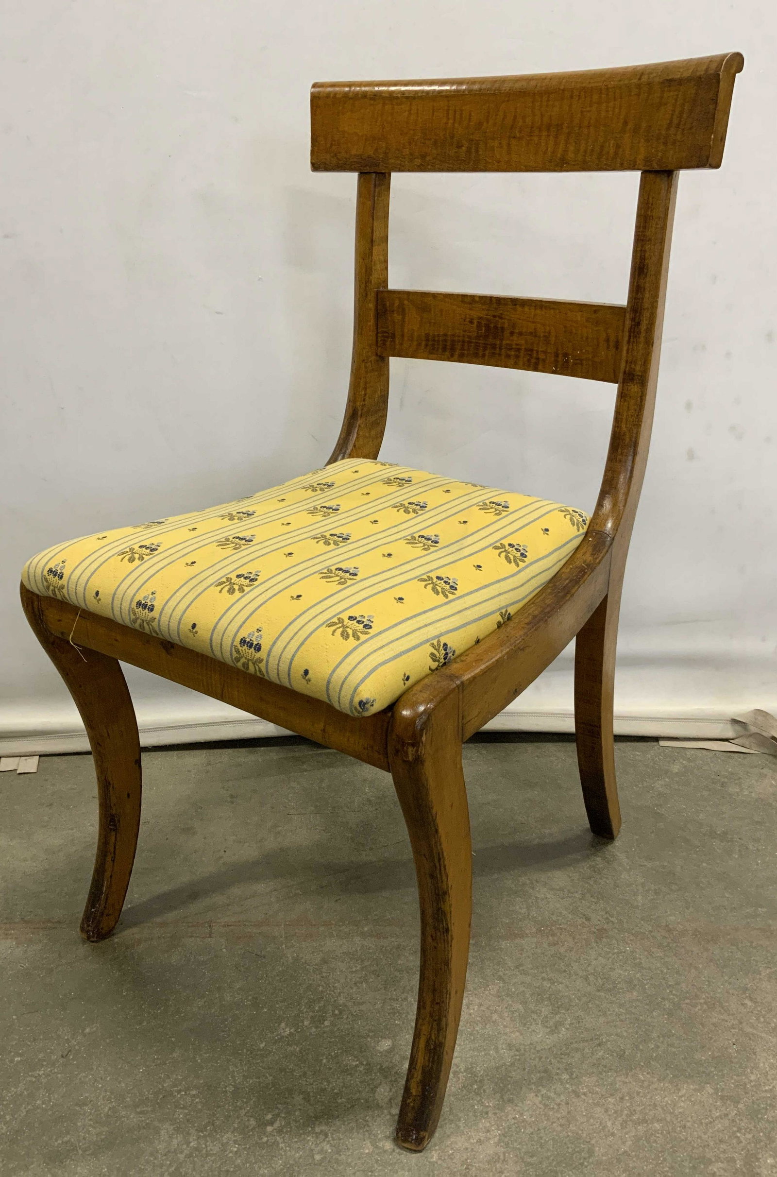 Vintage Side Chair w Upholstered Seat: Vintage, possibly antique, side chair. Seat cushion is removable and upholstered. Decorated with floral patterns and multi toned striations. Legs are splayed, saber shaped. Surface wear to frame, cons