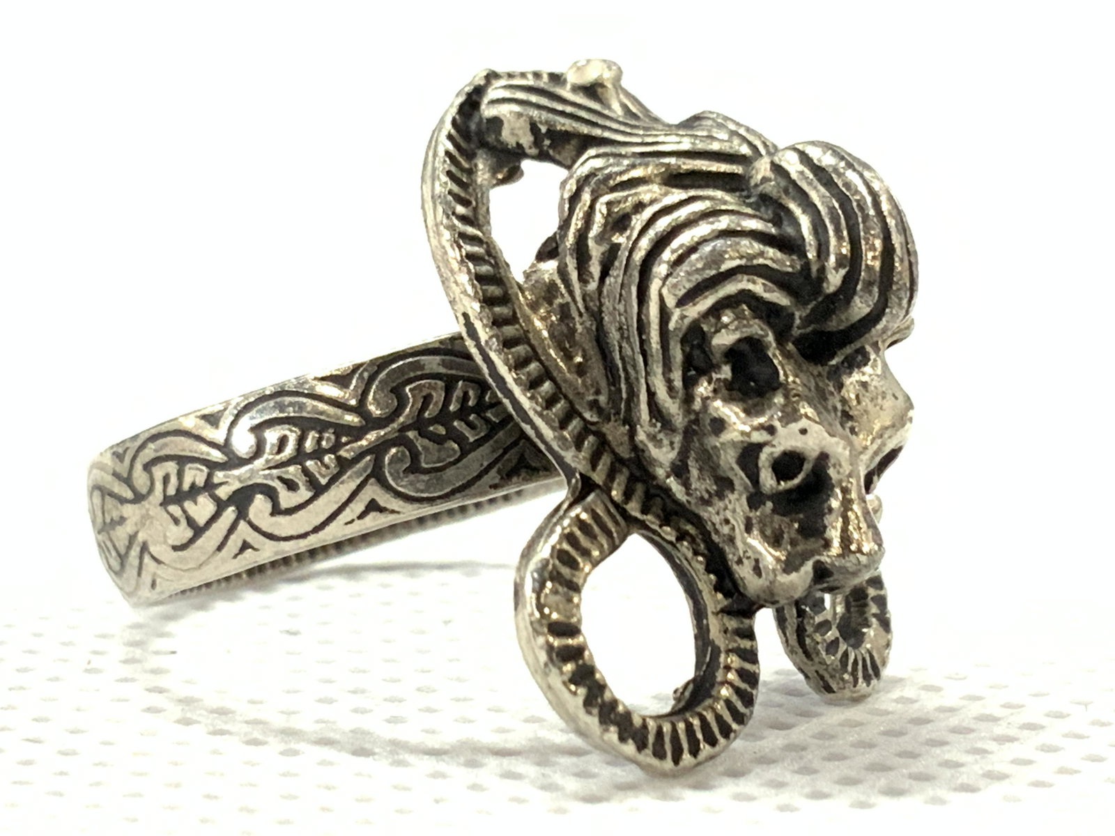 Vintage Ornate Etched Lion Ring: Vintage ring possibly pewter, with the head of a lion with a snake like shape wrapped around the head, band of the ring is etched with leaf designs. Size 7. Minor wearing to metal. Lion ring, animal r