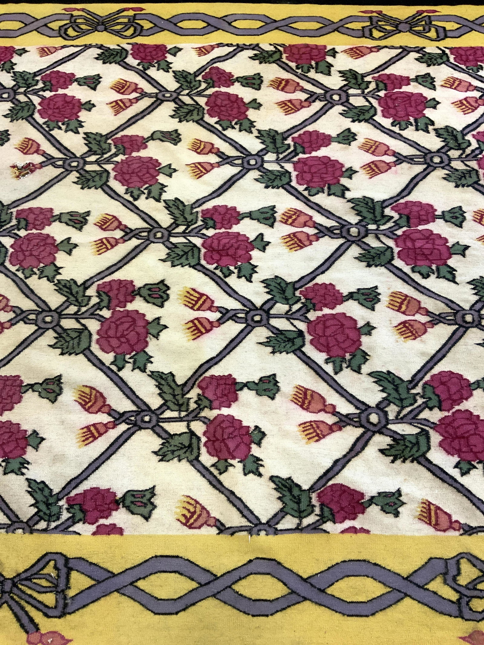 Vintage Handmade Wool Area Rug: Rug is vintage. Piece is wool possibly handmade. Rug has floral, & leaf detail. Outer edge is black & yellow toned. Rug measures approx 110 inches long 72 inches wide. Rug, carpet, wool rug, vintage r