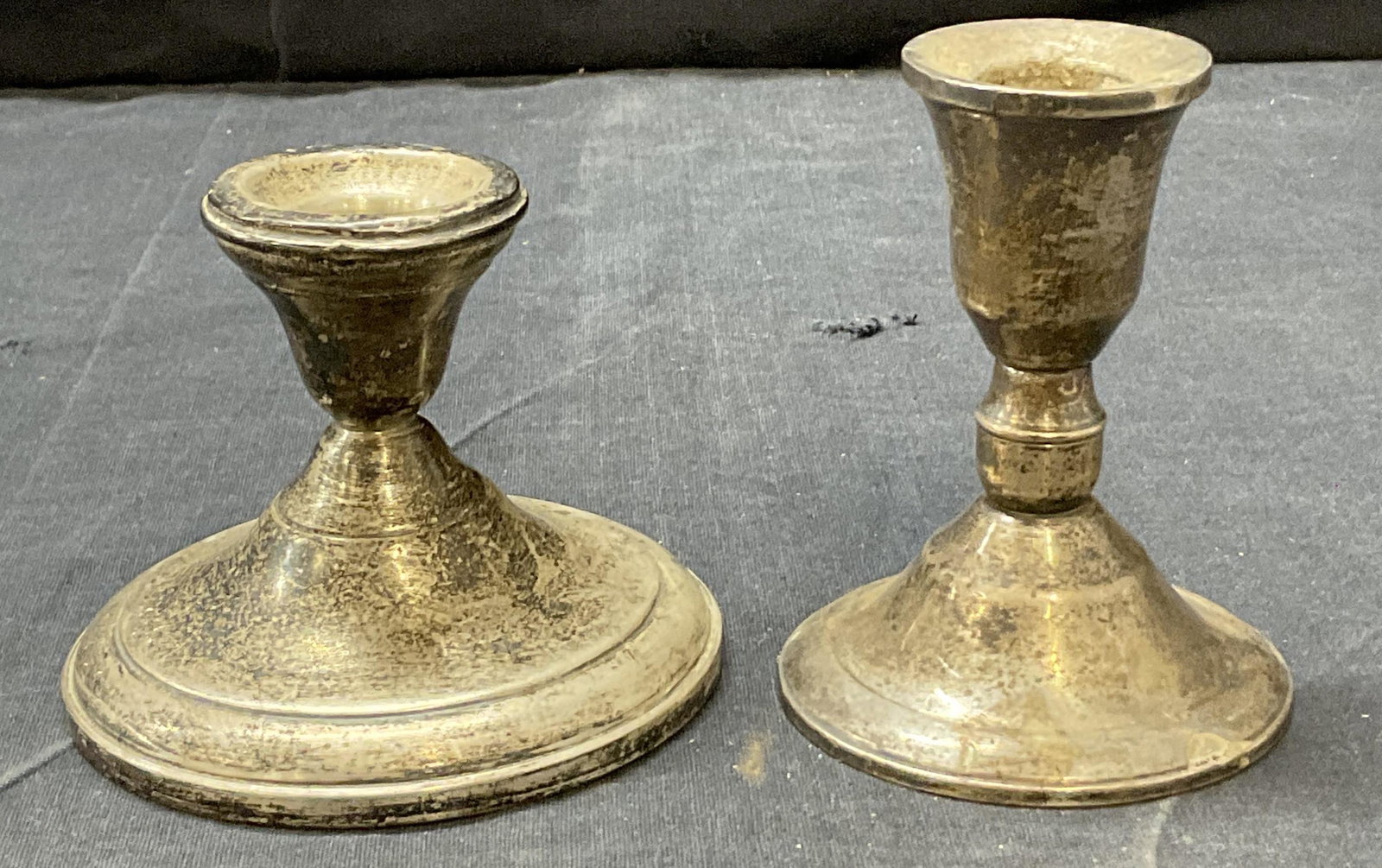 Lot of 2 Sterling Candle Holders: Lot of 2 Sterling Candle Holders, underside reads ‘Sterling Reinforced With Cement, Sterling Duchia Creation Weighted. Tallest measures approx 4H inches. Total weight of both pieces 12.74 ozt. Surfa