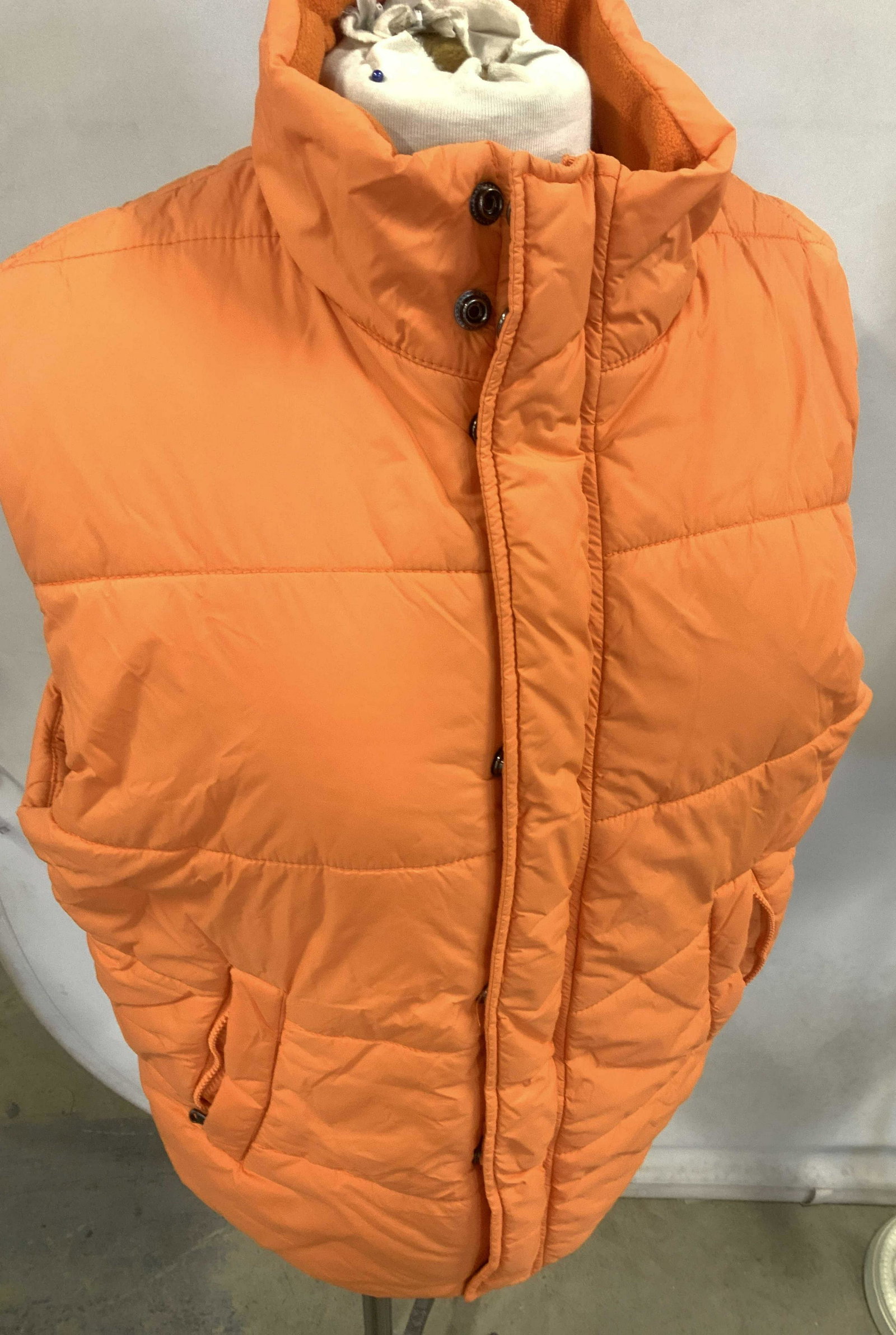 Express Design Studio Nylon Puffer Vest: Bright orange vest with zipper and snap closure, labeled Express Design Studio, size Medium. Zippered hand pockets , inner pockets, polyester fill, nylon exterior. Like new. 26 in. Long. Property of M