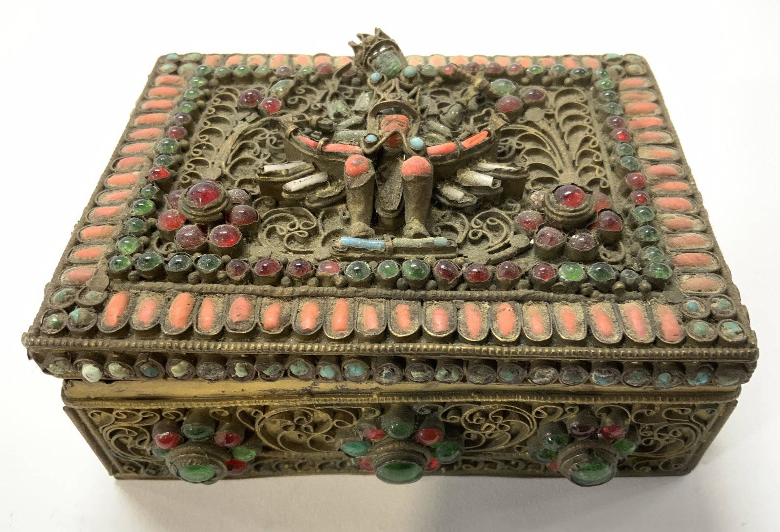 Asian Lidded Metal Trinket Box W Enameled Detail: Trinket box is vintage possibly antique. Piece is gold toned and metal with multi toned enamel detail. Box is lidded. Center of lid has figural detail. Trinket box, keepsake box, Asian keepsake Box, e