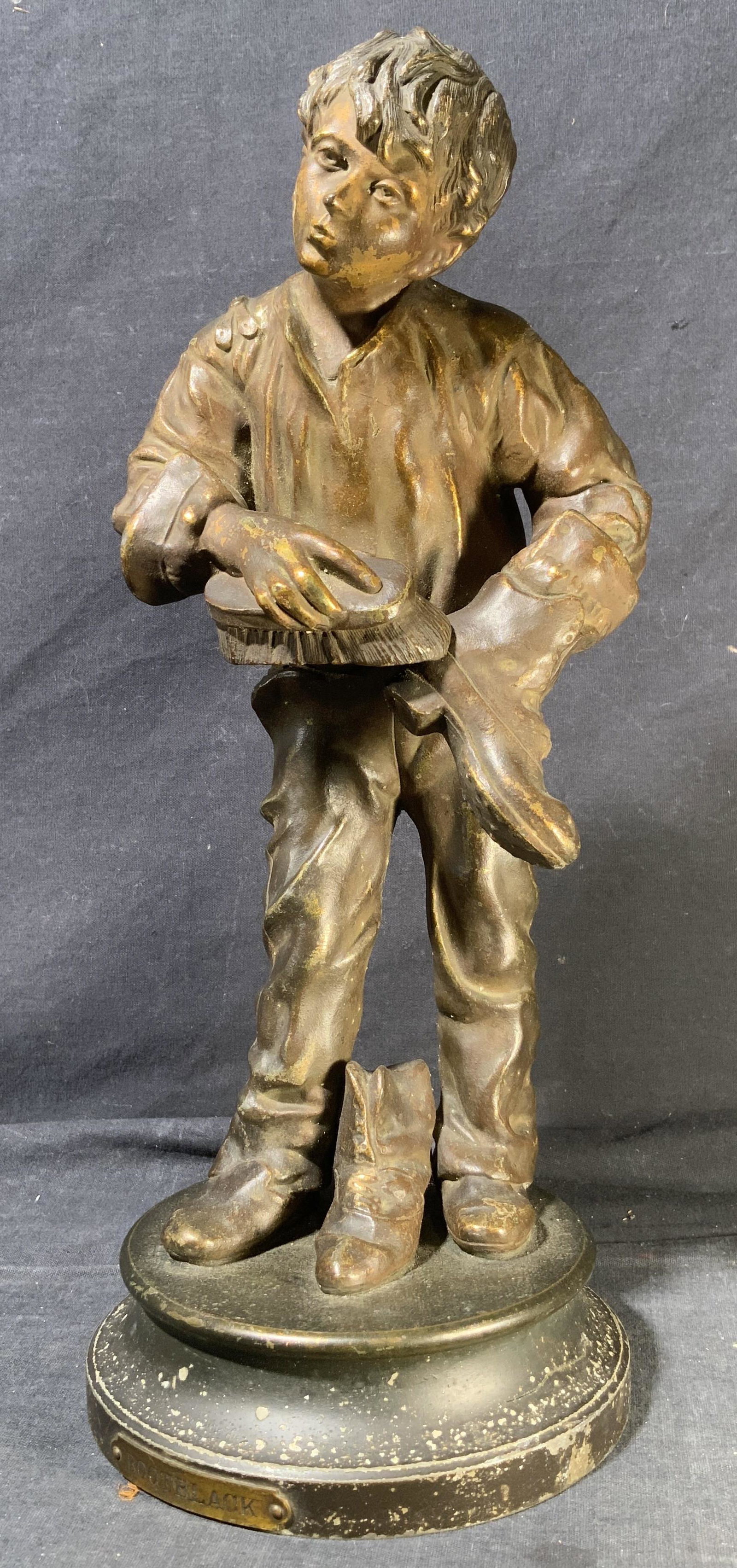 Cast Bronze Sculpture of a Shoeshine Boy: Cast Bronze Sculpture of a Shoeshine Boy, plate as base reads BOOTBLACK, verso has Unity Club, inscribed, boy is seen shining a lake of boots, one in his hands and another by his feet, measures 5 1/4 