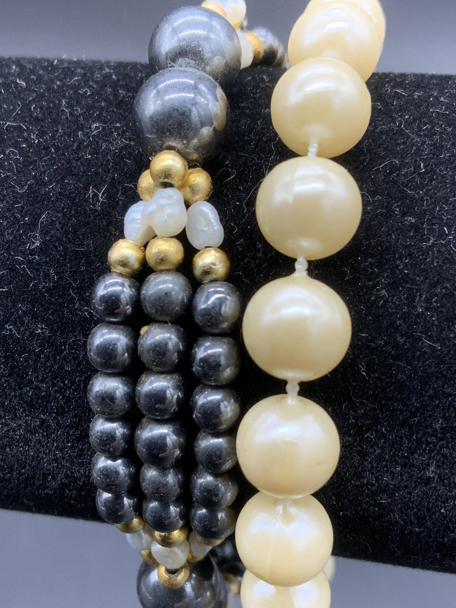 Pair of Pearlescent Bracelets: Pair of Pearlescent Bracelets, one with circle clasp, pearlescent beads measure approx 6 mm., bracelet measures approx 3 1/2 in. diameter., the other is costume Tahitian pearls with pearlescent and go