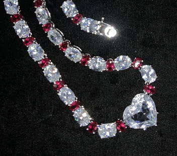 LANDAU Ruby & Crystal Sterling Silver Necklace: SIGNED NLH LUXURY NECKLACE full of bling. 19 in. Sterling Silver Necklace hallmarked 925 and Signed NHL , can be adjusted to 14 in. by removing section of secure box clasp. 34 Oval rubies, 5 x 3