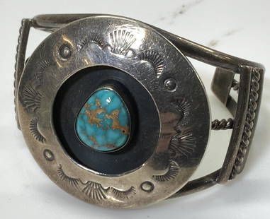 Handmade Southwest. Sterling Lander Turquoise Cuff: luxury Artisanal handmade sterling silver cuff bracelet with center Lander Blue Turquoise style stone, possibly other stone, bezel set in sterling with etched sterling silver medallion. 1.5 in.