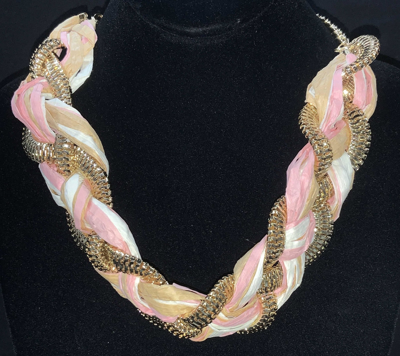 Braided Raffia and Gold Tone Chain Necklace, Sgn: This necklace is lightweight and composed of pink, white and tan raffia braided with a wide god tone chain. Signed NY on charm, adjustable length, 14-15 in. Choker necklace, costume jewelry, signed NY