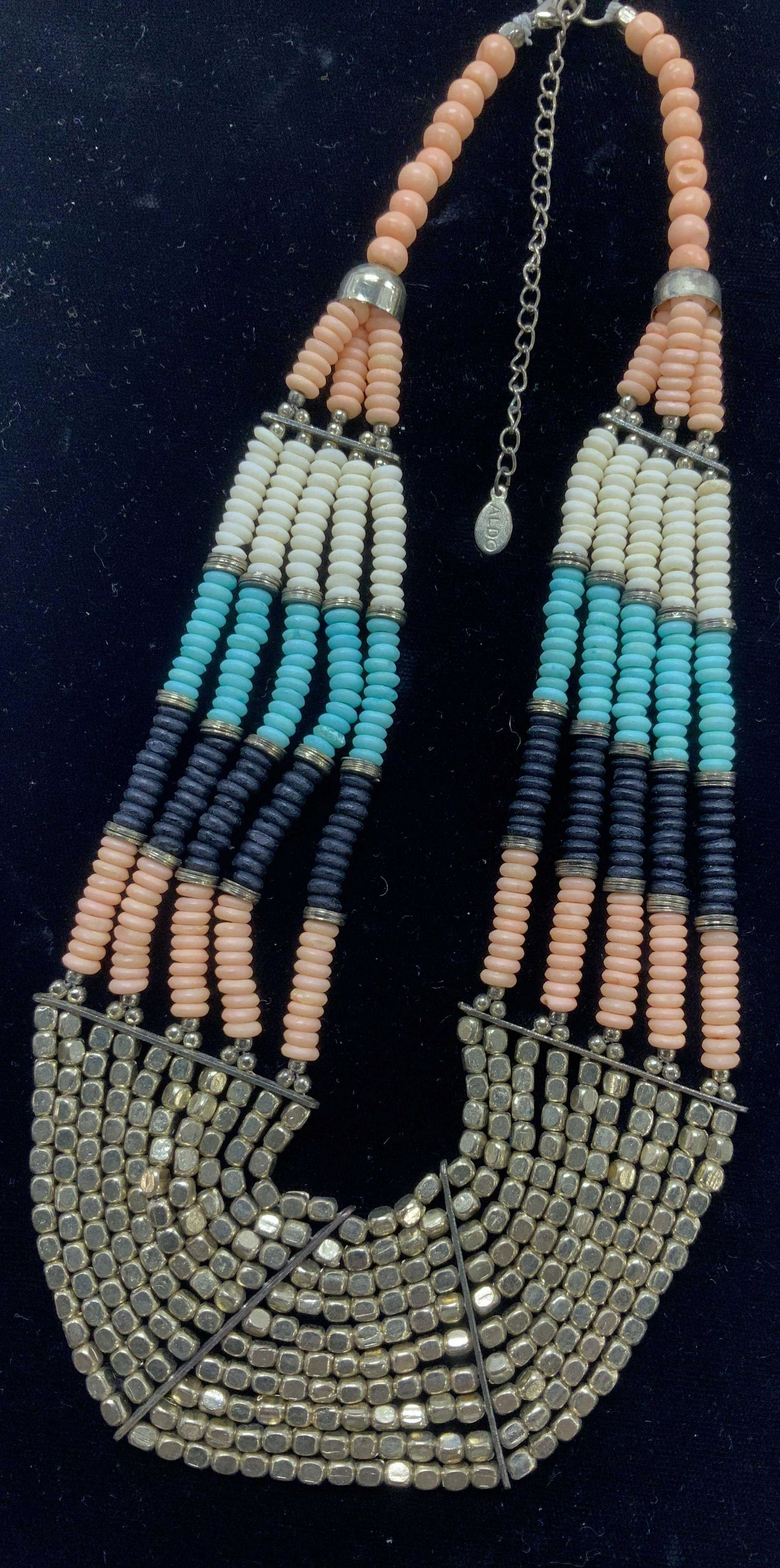 ALDO Hand Beaded Necklace w Golden Nuggets: Multi color disc beads, stacked by color- light coral, white, black and aqua beads. Lower half of necklace all gold tone nuggets. App 2 in. Wide, gradually becomes slimmer toward neck. Adjustable 16-1