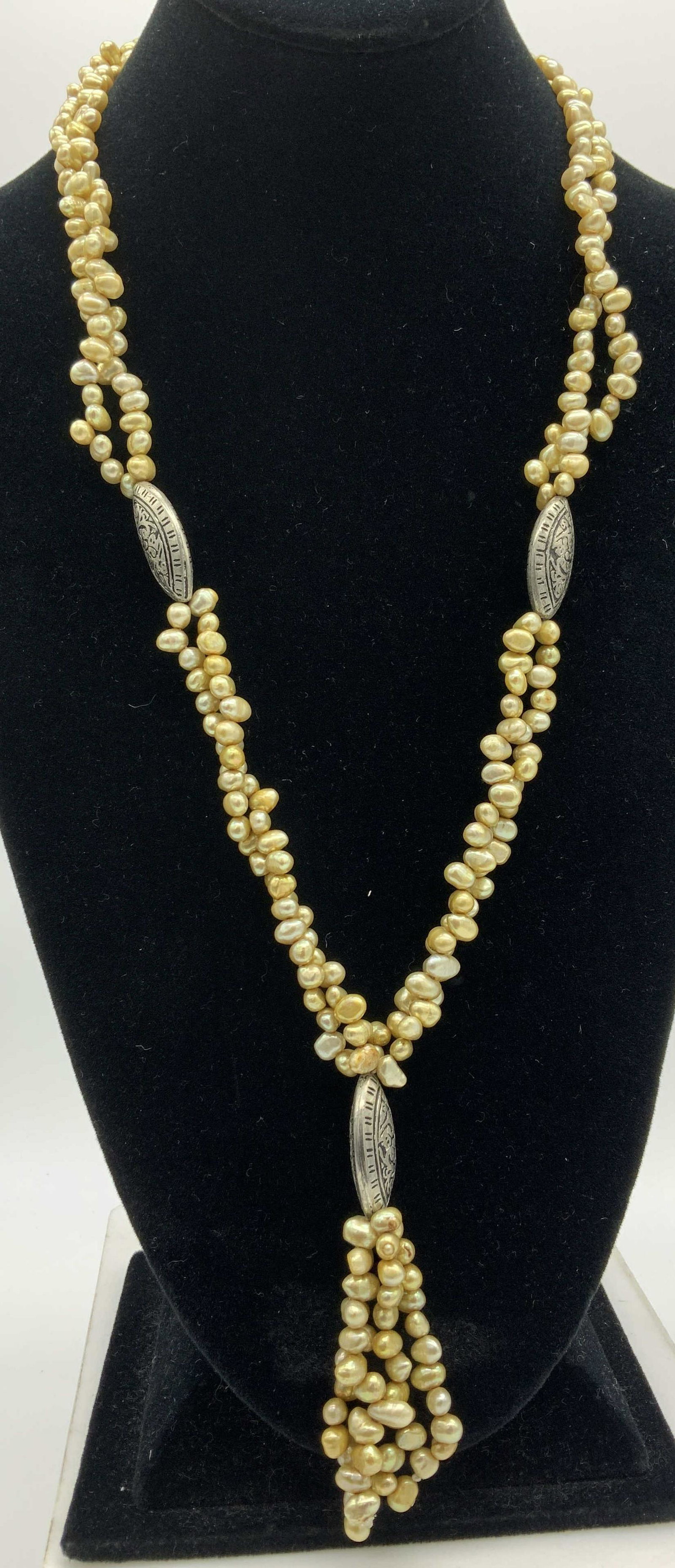 South Sea Freshwater Multi Pearl Neckalce: double strand 24 in. freshwater Pearl necklace, south sea toned pearls , app 6 x 4 mm. Accented by chased silver tone bead ( possibly sterling) and pearl tassel pendant, drop is 3.5 in. Hand crafted v