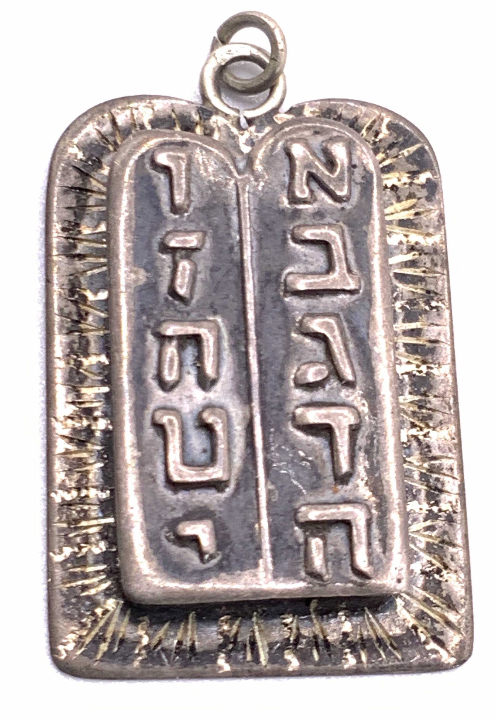 Vintage STERLING SILVER Judaica Pendant, Jewelry: A sterling silver pendant. Vintage, possibly antique. Raised Hebrew writing to the obverse. Reverse signed STERLING SILVER, ISRAEL. Hole to reverse shows paper to interior. Bail to top. Total weight .