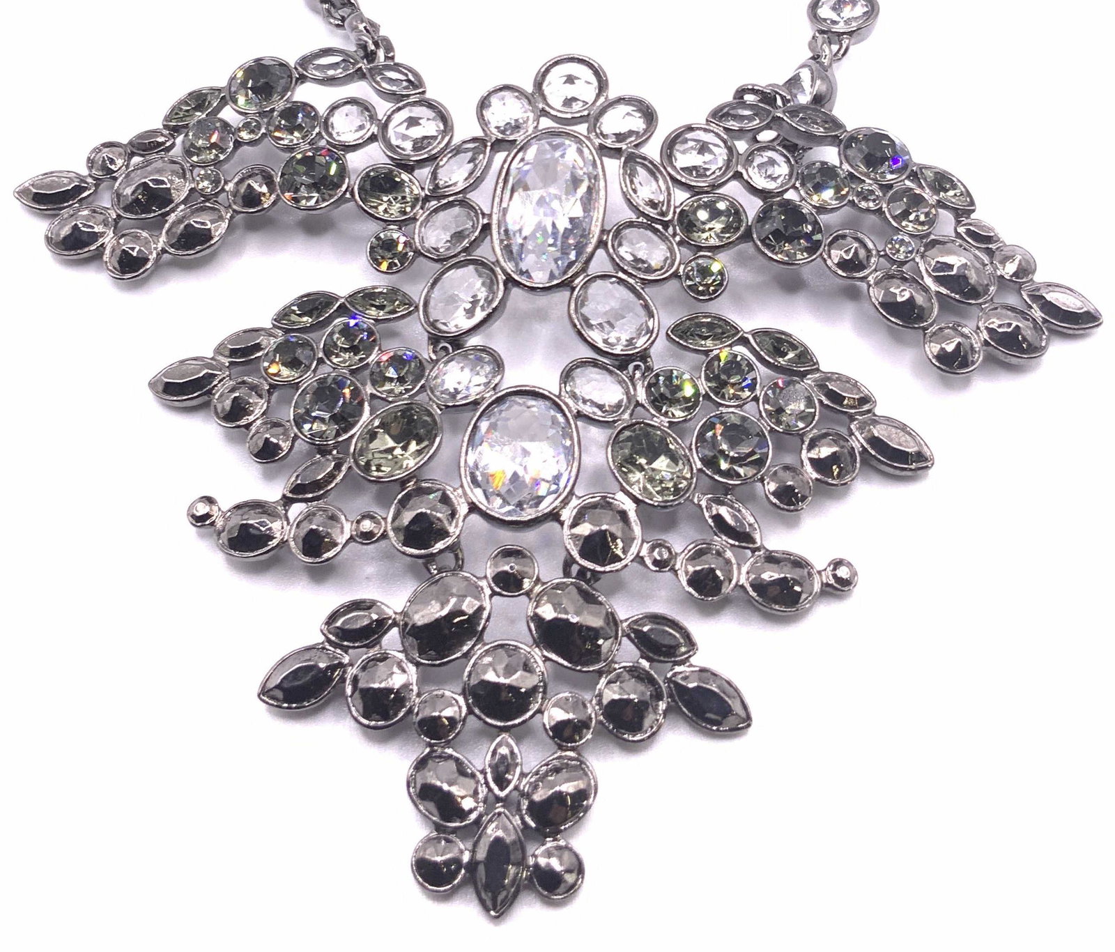GIVENCHY NWT Bejeweled Crystal Bib Necklace: Gunmetal toned metal chain necklace with layered faceted crystal bib. Crystals are neutral, colorless, and metallic hues. Lobster claw clasp closure. Original tag attached reads GIVENCHY, $325. Neckla