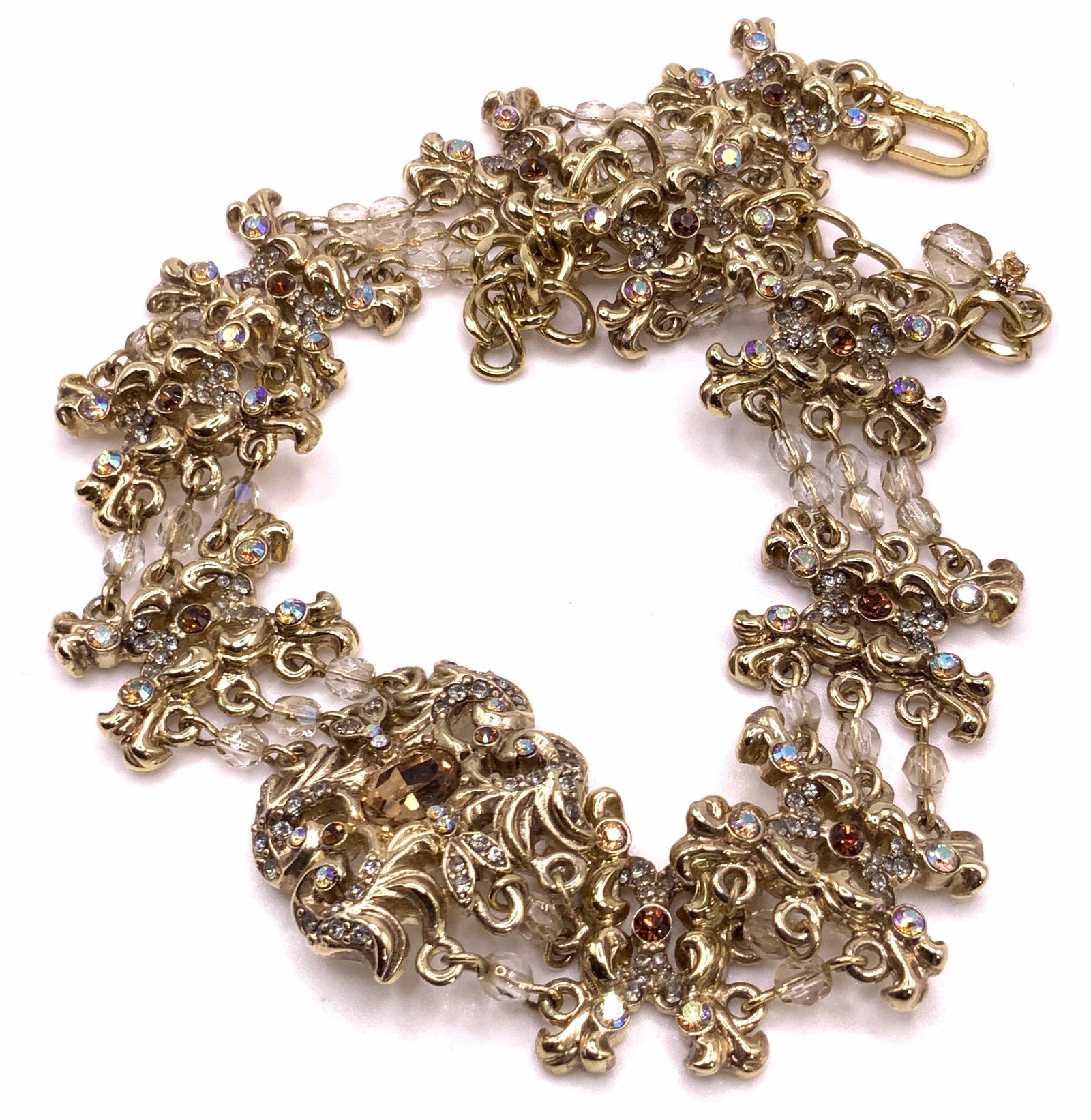 Bejeweled Crystal Choker Necklace, Vintage Jewelry: A vintage gold tone metal panel necklace featuring Aurora Borealis crystals, amber hued crystals, and colorless crystals. Crystals are faceted circular and oval forms. Choker style necklace, length ap