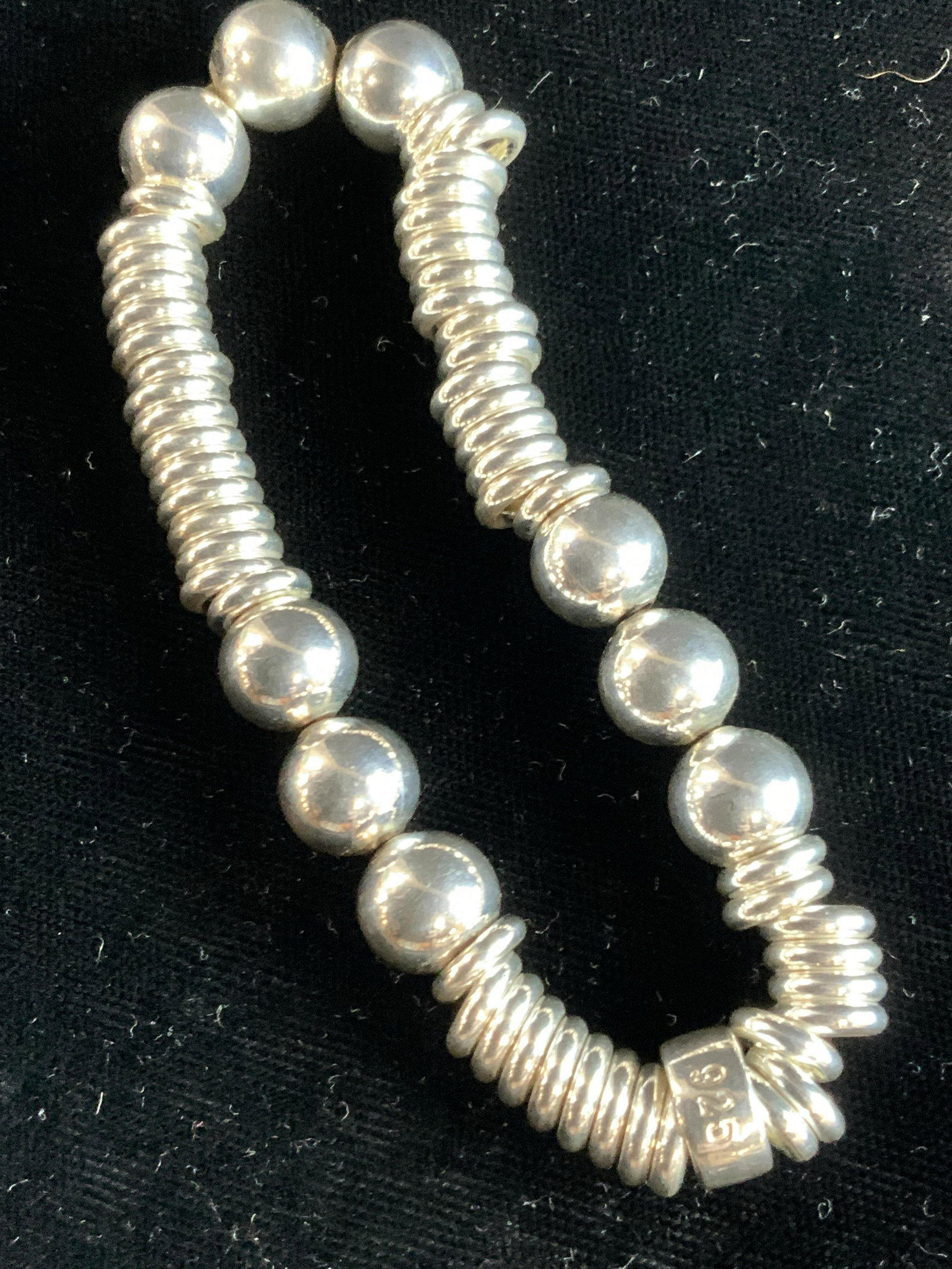Sterling Silver Stretch Breaded Bracelet: A stretch beaded bracelet made with O rings, polished circular beads and a flat bead, marked 925 on flat bead. Approximately 2.75 inch diameter, total weight is 1.19 ozt. Sterling silver stretch brace