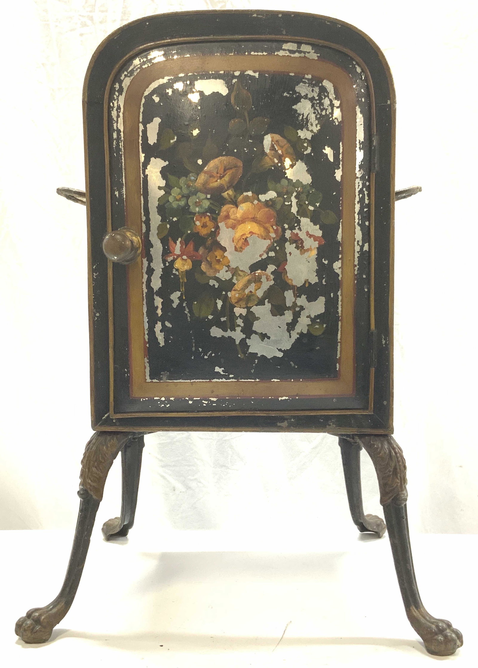 Antique Tole Fireplace Warming Oven: Antique Tole Fireplace Warming Oven, four legs with clawed feet, appears to be crafted from iron and tin, floral motif, side handles, some chipping to paint, twist to open knob, measures approx 26H x