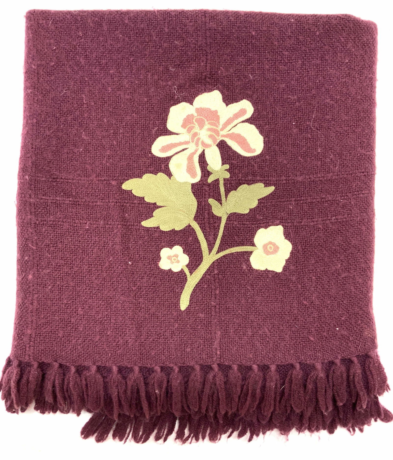 THE THREE WEAVERS Mulberry Embroidered Blanket: Mulberry toned cotton woven blanket, embroidered with a flower using tan, pink and green toned threading. Marked on tag, The Three Weavers, Houston Texas, Hand woven 100% Virgin Wool. Approximately 76