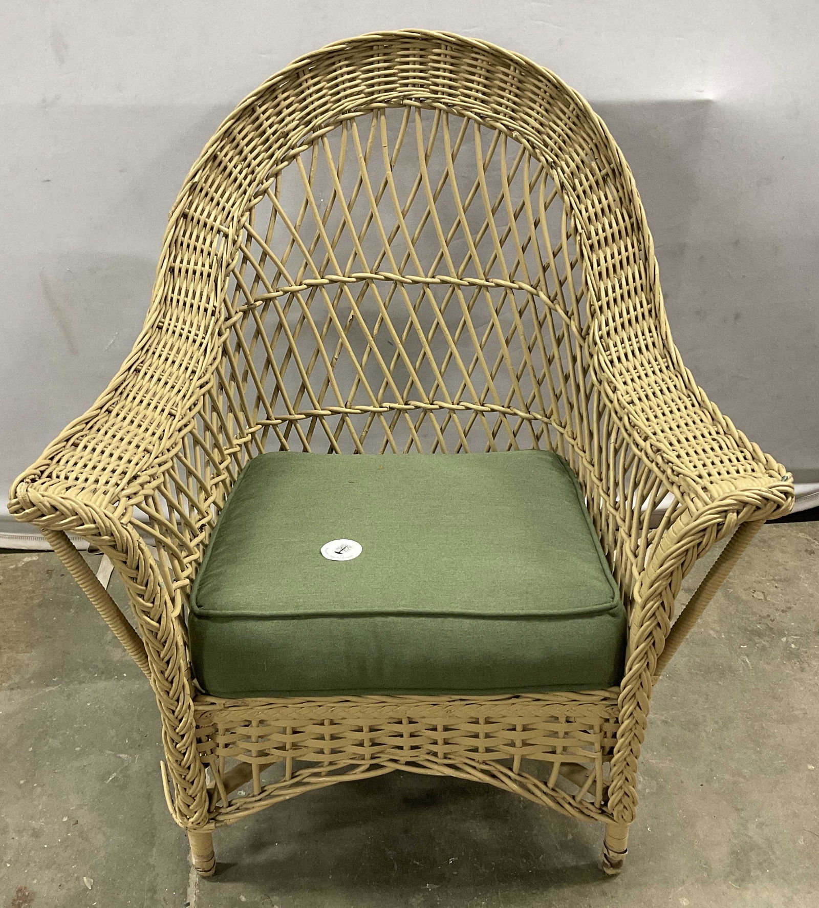 Sand Toned Wicker Chair: Wicker chair painted in a sand toned color. Arched backrest has diamond shaped cross weaving. Cushion is able to be removed. Property of Martha Stewarts East Hampton Long Island, NY Estate. Outdoor se