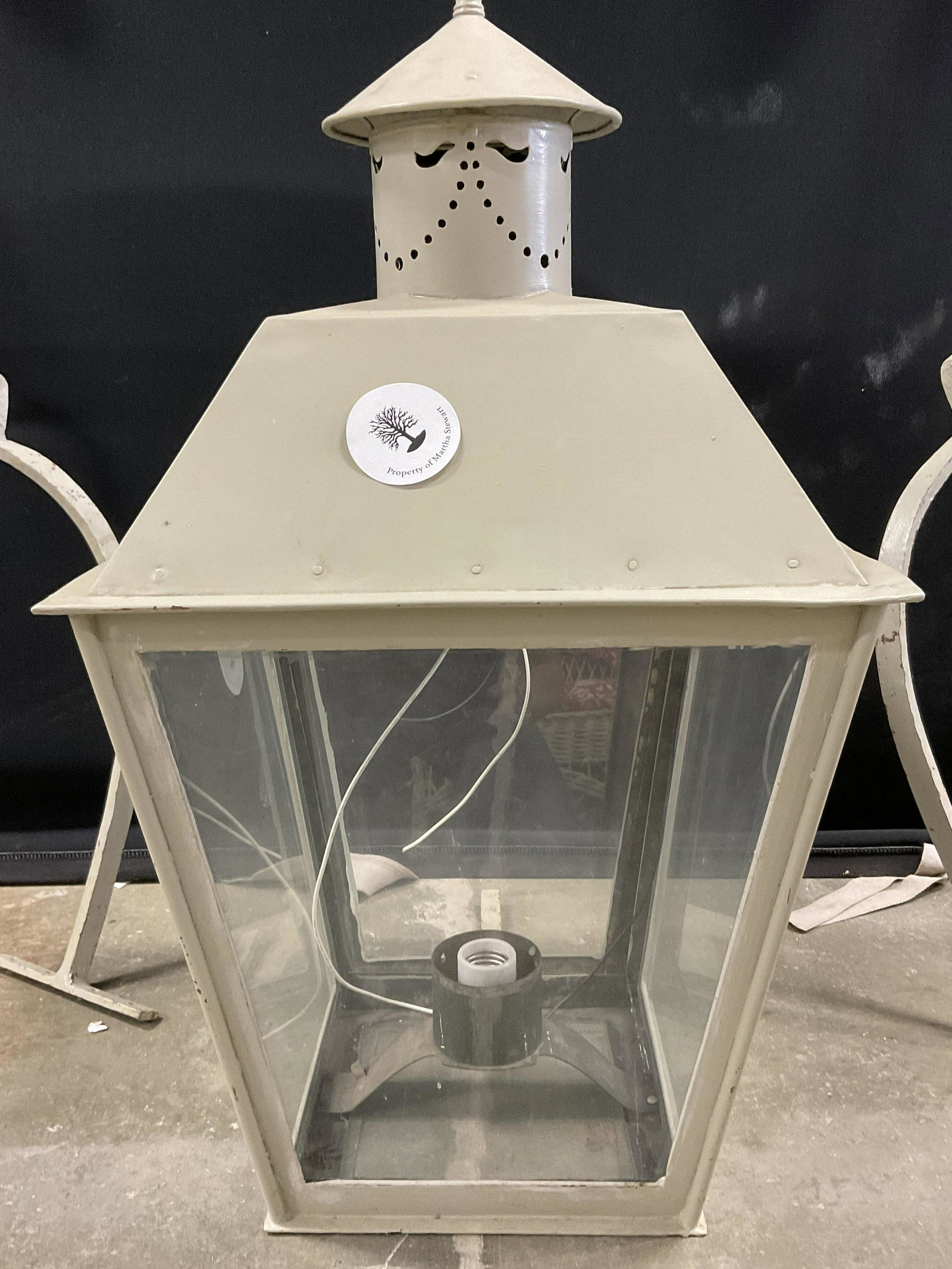 Grey Lantern & Brackets: One bulb socket lantern. Color of piece & brackets are of a grey tone. 4 glass sides to lantern along with decorative top to piece to illuminate light. Brackets are curved. Brackets measure approx 39 