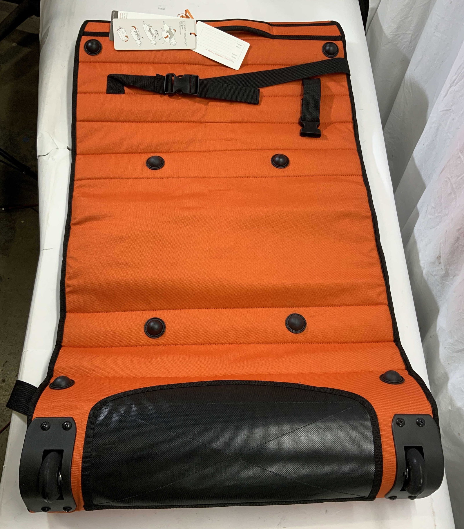 STOKKE PRAM PACK In Orange & Black NWT: Piece reads STOKKE PRAM PACK. Piece is orange with black toned text & interior. Pack is new with tags STOKKE, stokke pram pack, stroller bag, pram bag, orange pram pack. 60 inches long 45 inches wide 