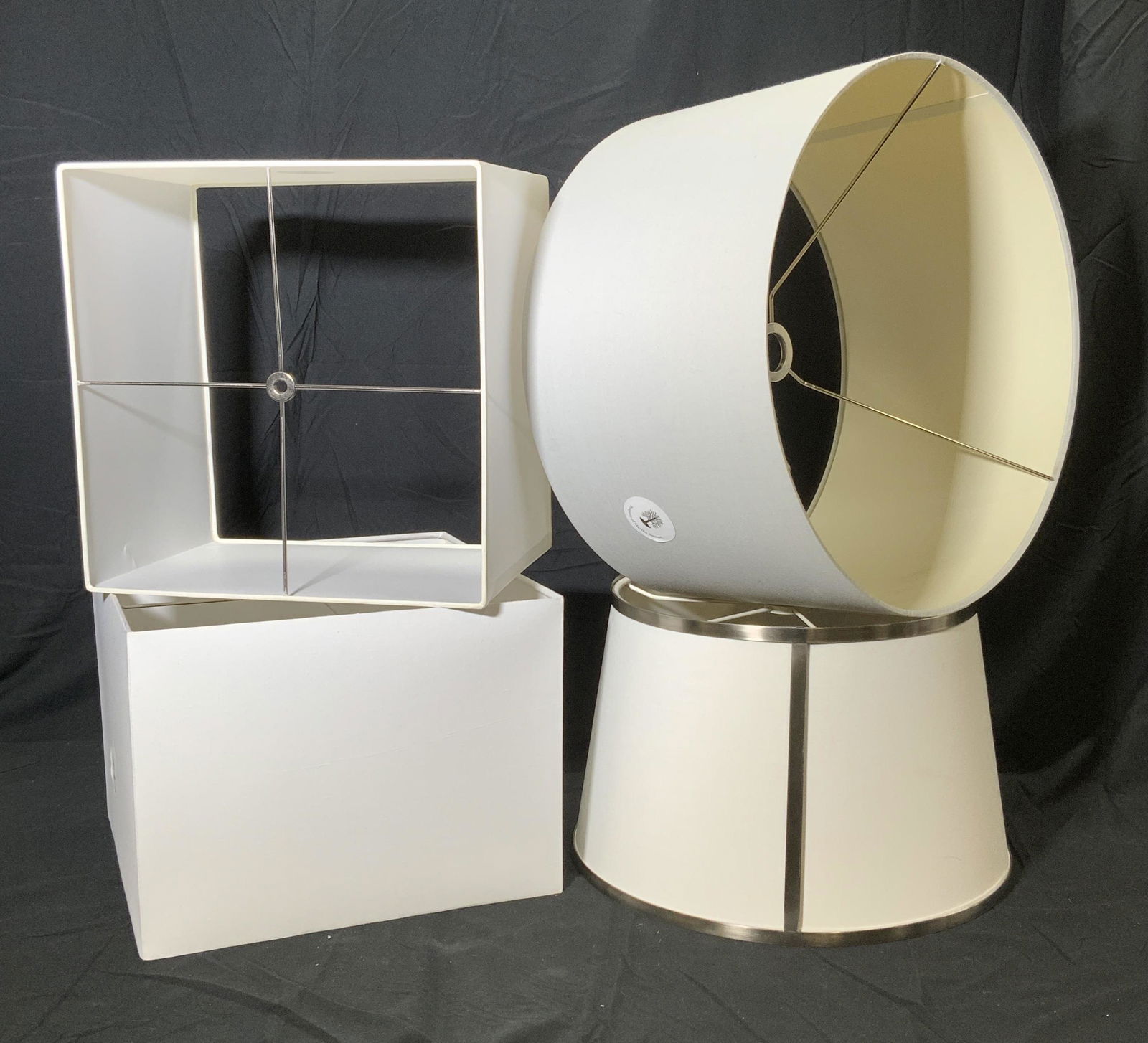 Assorted Large Square and Drum Lampshades: Assorted group of white and light grey colored lampshades. Two square lampshades in white, measure approx. 14.75L x 14W inches each. One drum lampshade in light grey, measures approx. 10.5 inches tall