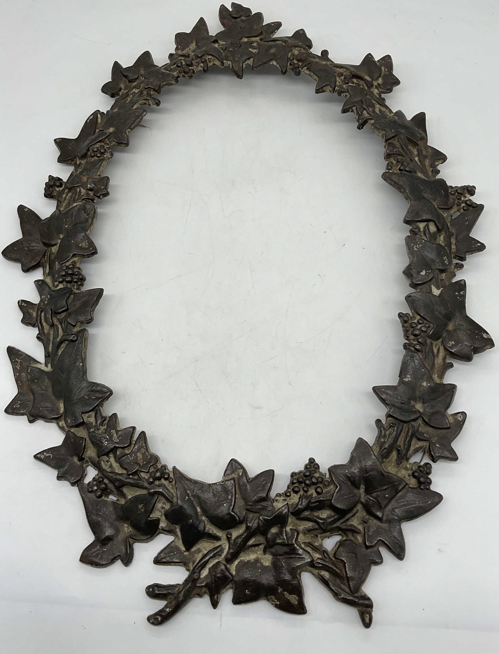 Antique Iron High Relief Leaf form Oval Frame: Antique Iron High Relief Leaf form Oval Frame. Resembling English Ivy. Metal frame has significant weight to it. Inside dimensions measure approx 13.75 x 10 inches. Could be used for a mirror. Propert
