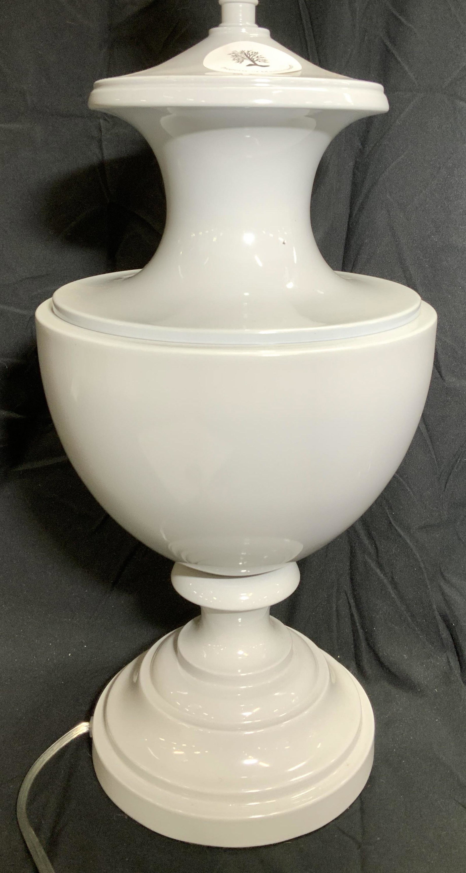 Green Enamel Urn Style Lamp: Contemporary lamp with simplistic neoclassical urn body, light grey enameled metal, clear color cord, turn switch. Underside with black felt protector. 22 in. Ht. 10 in. Width. Property of Martha Stew