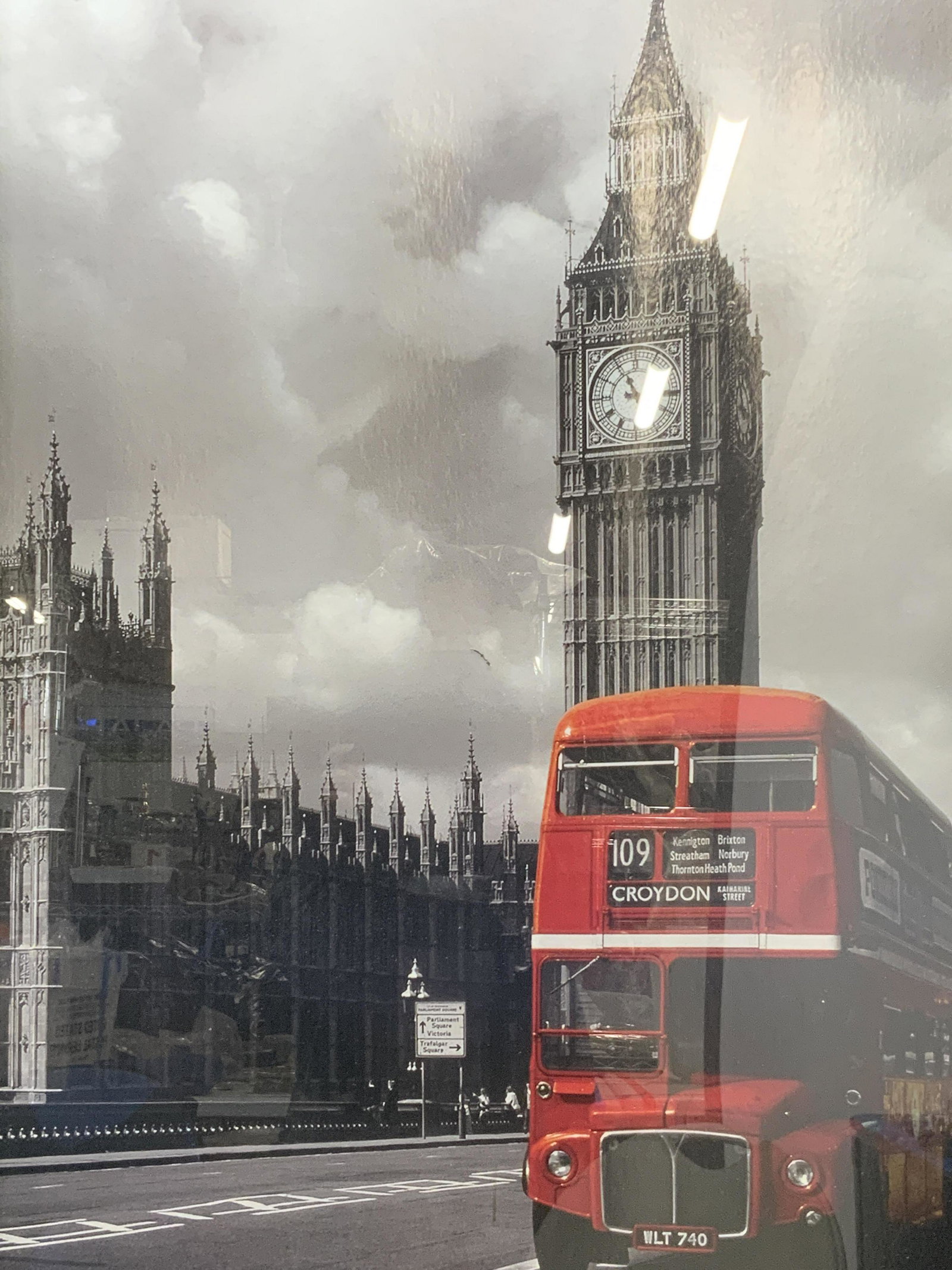 Big Ben Black, White, & Red Serigraph: Big Ben Black, White, & Red Serigraph, no apparent inscriptions, subject shows a vintage looking red bus driving on the road beside Big Ben and the Palace of Westminster in black and white. In frame m