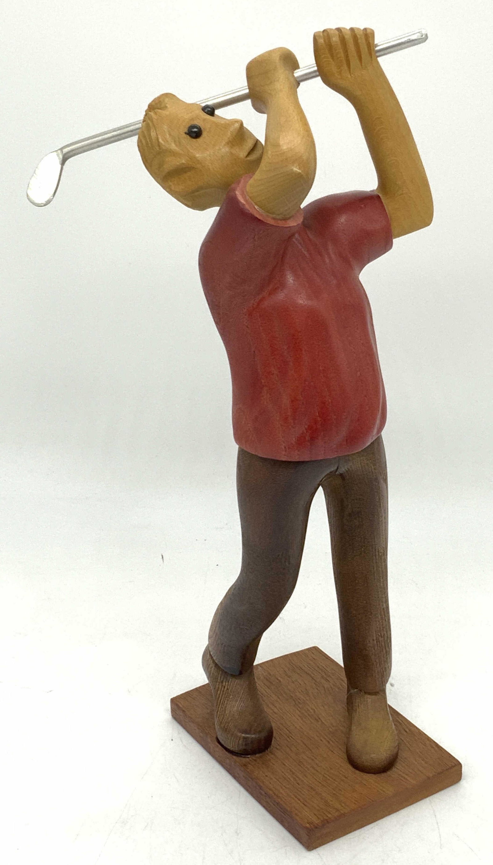 ROMER Hand Carved Wooden Golfer Sculpture, Italy: ROMER Hand Carved Wooden Golfer Sculpture, Italy, sanded and smooth wood, with red toned wood shirt and brown toned wood pants, swinging a silver toned metal golf club, black composite eyes, measures 
