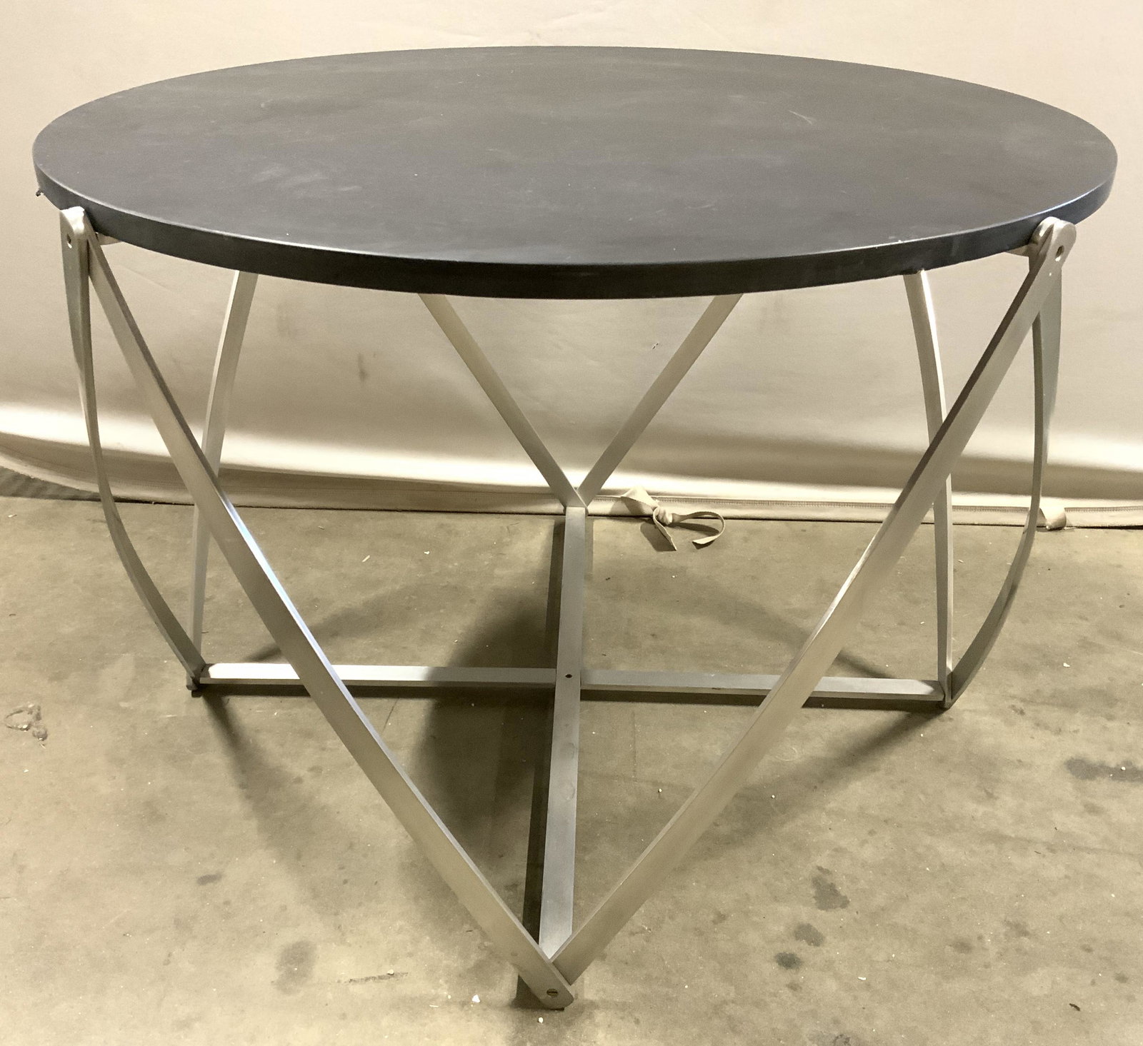 Circular Accent Table W Composite Top: Table has brushed metal base & black toned circular shaped top. Tabletop appears to be composite, possibly stone. Table measures approx 33.5 inches wide 23 inches tall. Table, side table, end table, a