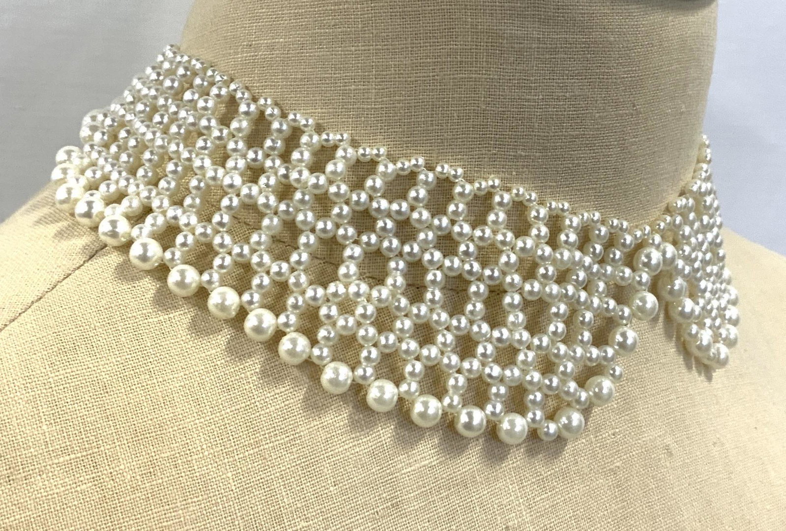 Pearlescent Collar Style Choker Necklace: Pearlescent Collar Style Choker Necklace, bronze toned strand, lobster claw clasp, adjustable length measuring from approx 14 - 17 in., woven pearlescent beaded strands with split in the center, beads