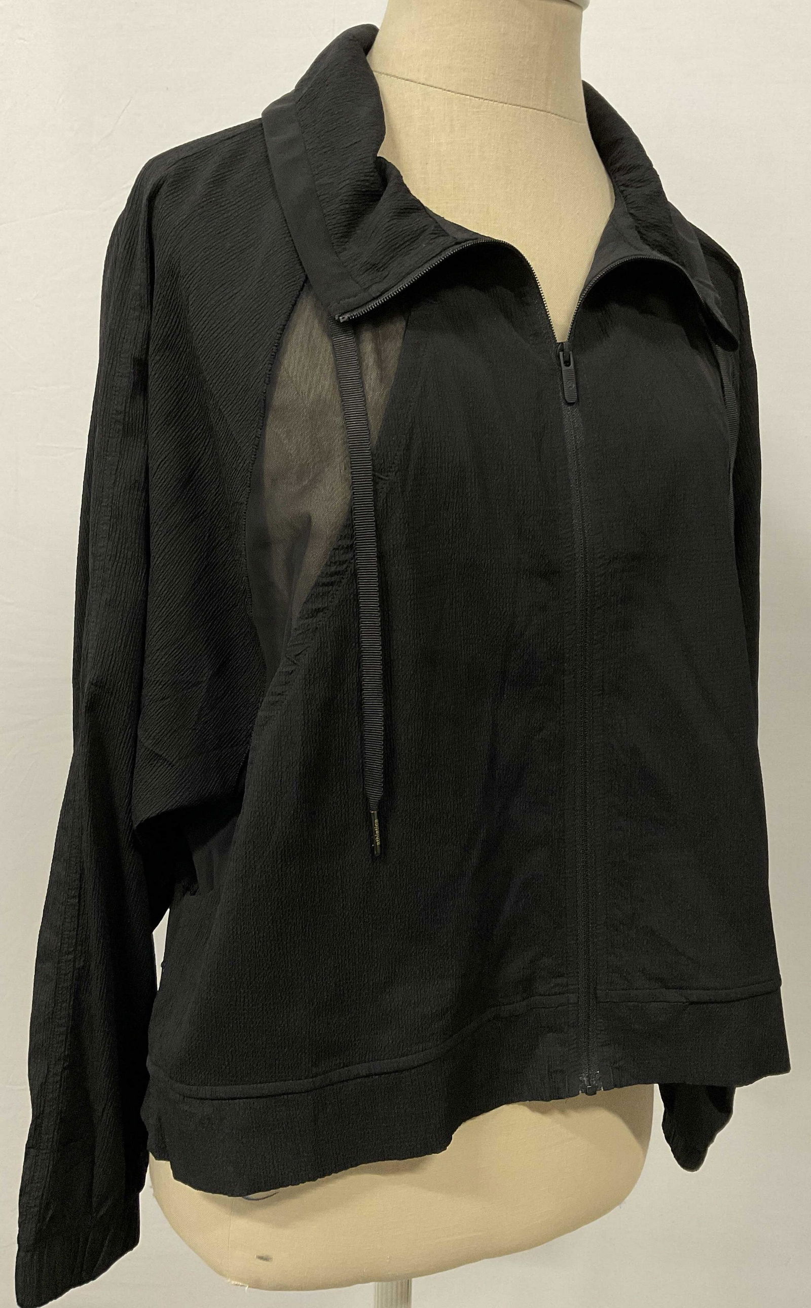 LULULEMON Black Windbreaker: Lululemon brand sign on zipper. From shoulder seam to bottom measures approx 20.5 inches. Arm length measures 28 inches. Some minor stains. Lululemon, LULULEMON wearable, LULULEMON wind breaker, LULUL