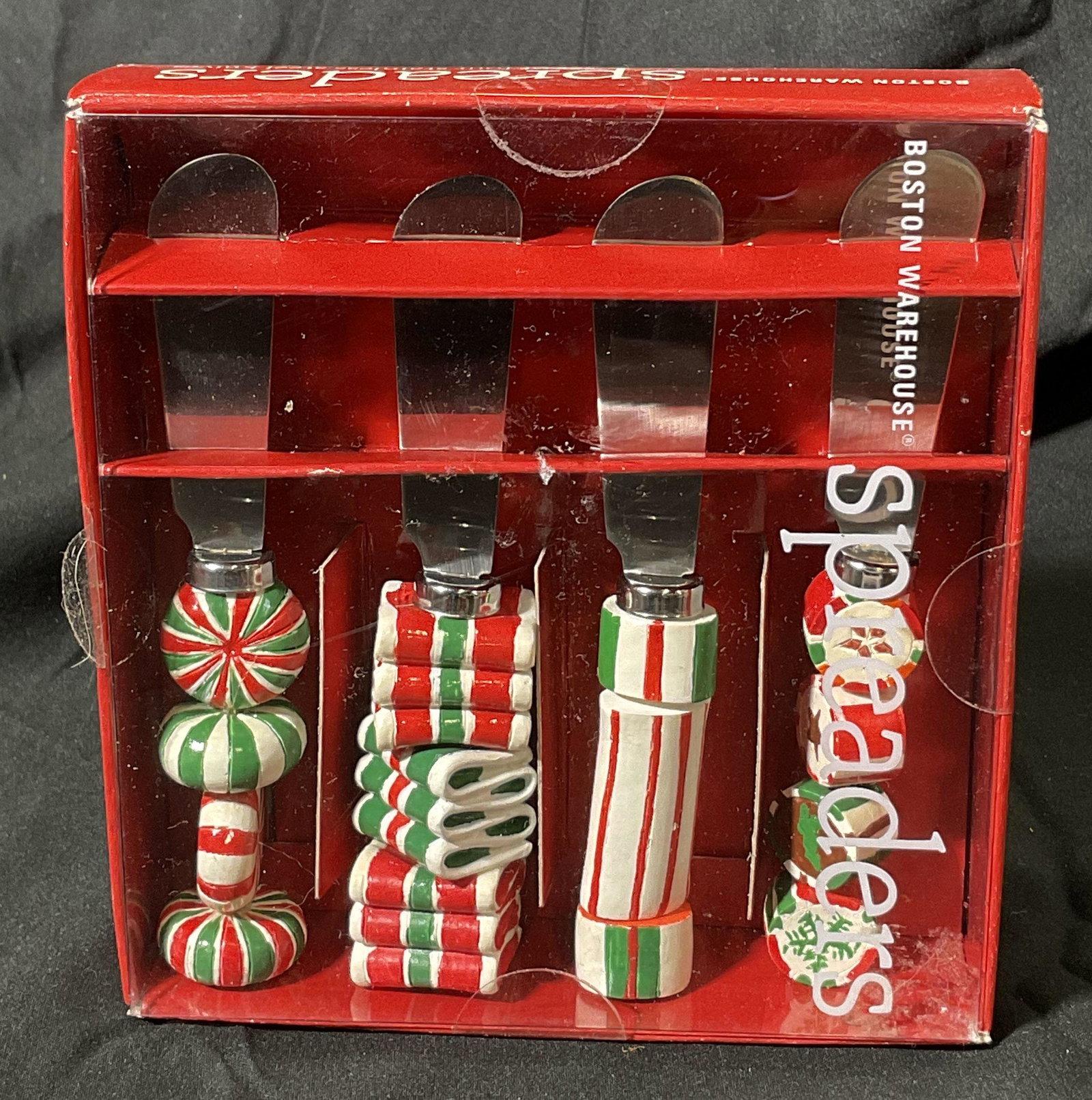 BOSTON WAREHOUSE Spreaders: Boxed Holiday themed spreaders. Colored with a variations of green, red, white and orange colors. Handles resemble holiday candies. In box, unopened. Kitchenalia, cheese spreader, candy themed, holida